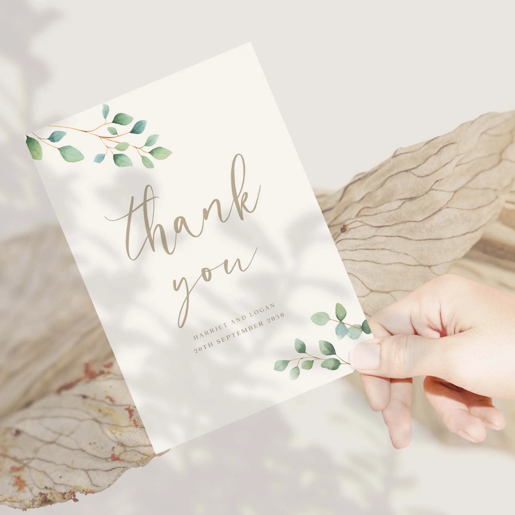 Hand holding a Eucalyptus Calligraphy wedding thank you card