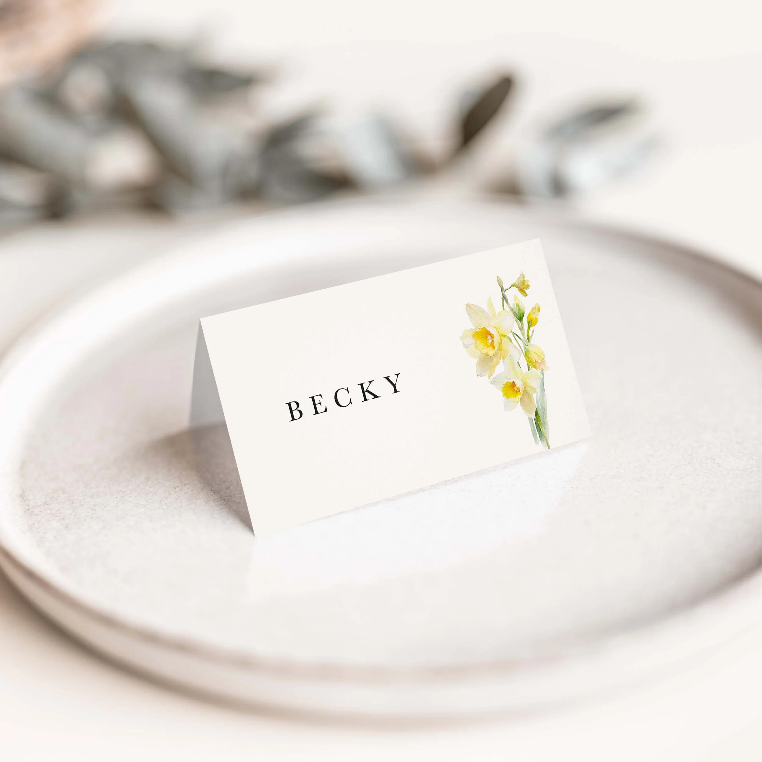 Daffodil wedding place card with yellow daffodil floral illustration and elegant typography on luxury off-white card