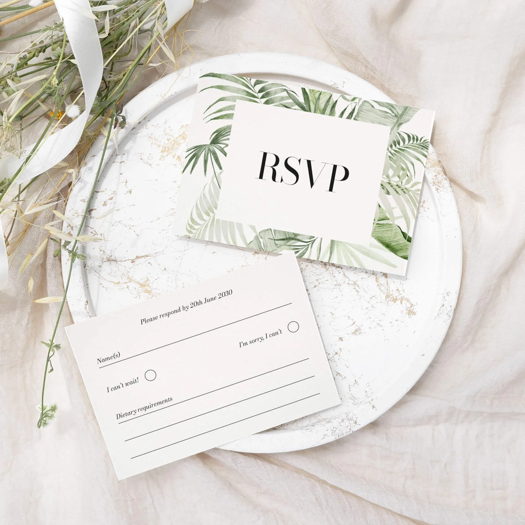 Tropical wedding RSVP card with watercolour monstera and palm leaf border illustration on luxury off-white card