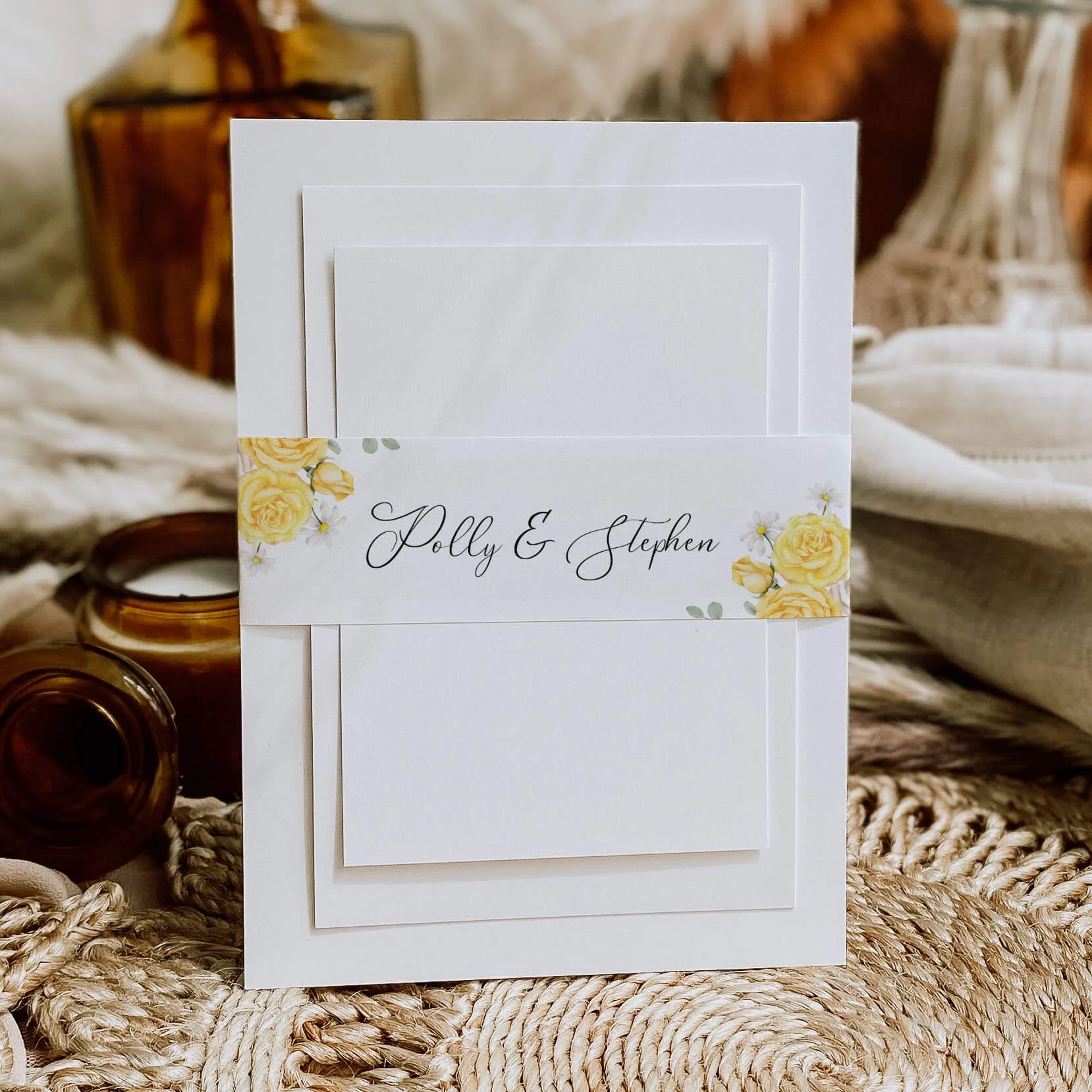 Summer Rose wedding belly band with soft yellow rose floral design and personalised couple names wrapped around luxury invitation suite