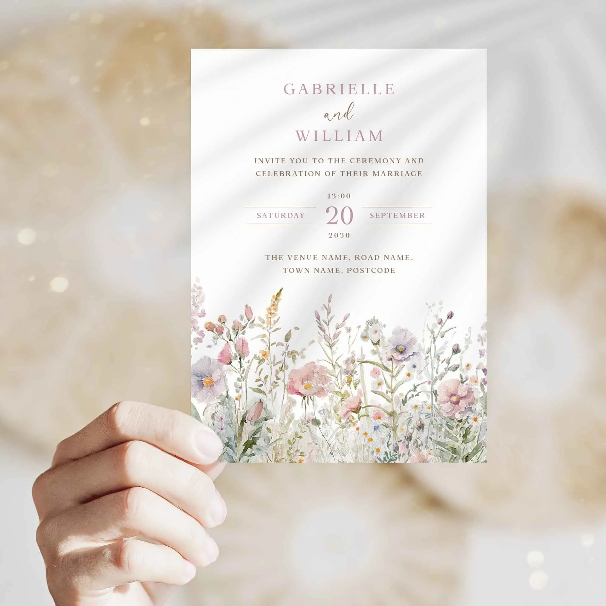 Hand holding Pink Wildflower Fields wedding invitation showing size and printed design details