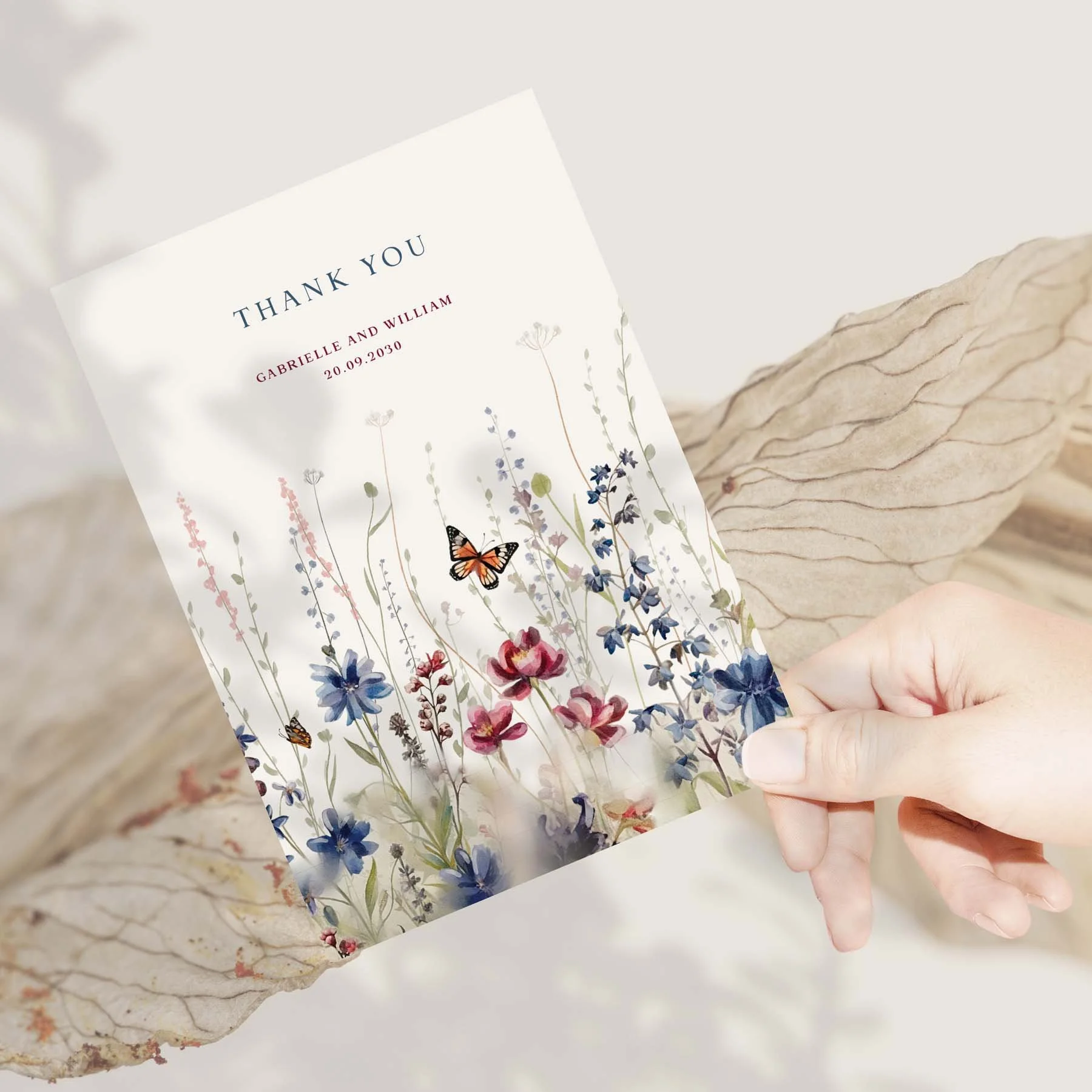 Hand holding a Navy Blue and Red Wildflowers wedding thank you card