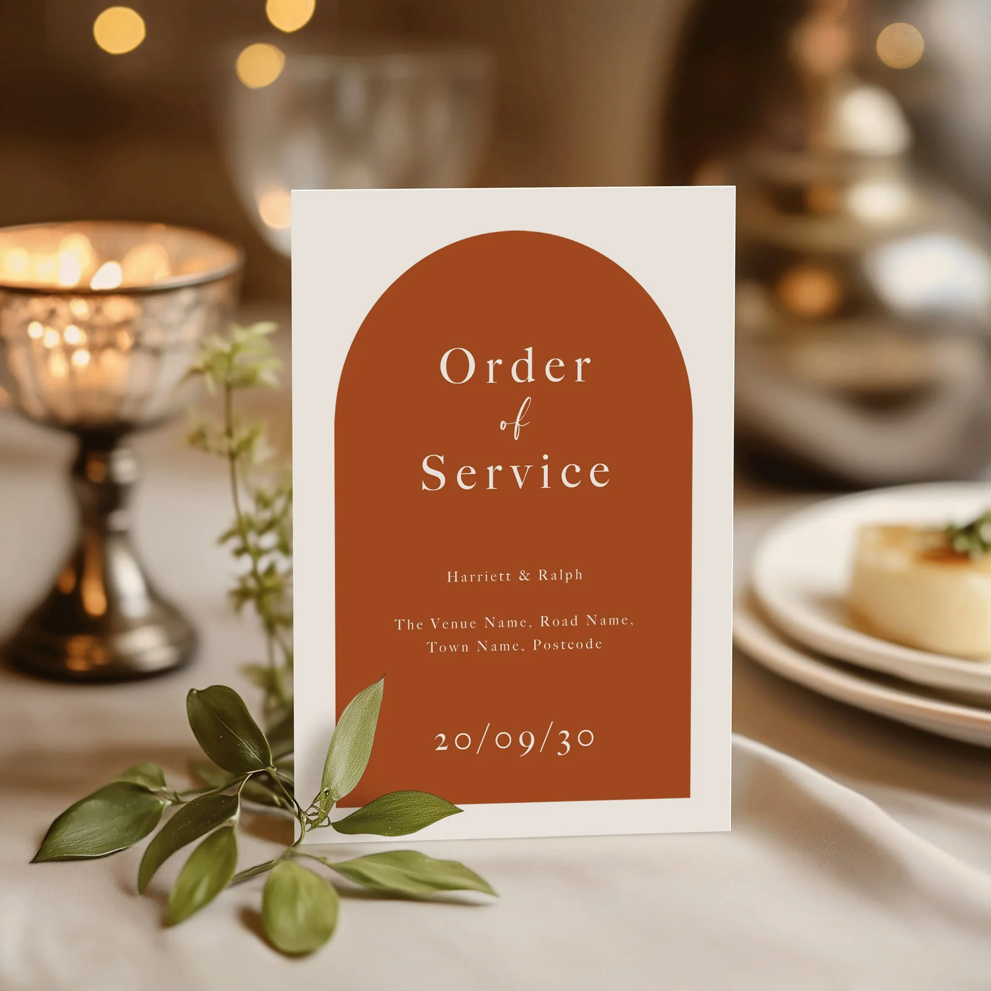 Orange Arch design wedding order of service standing upright on a wedding day