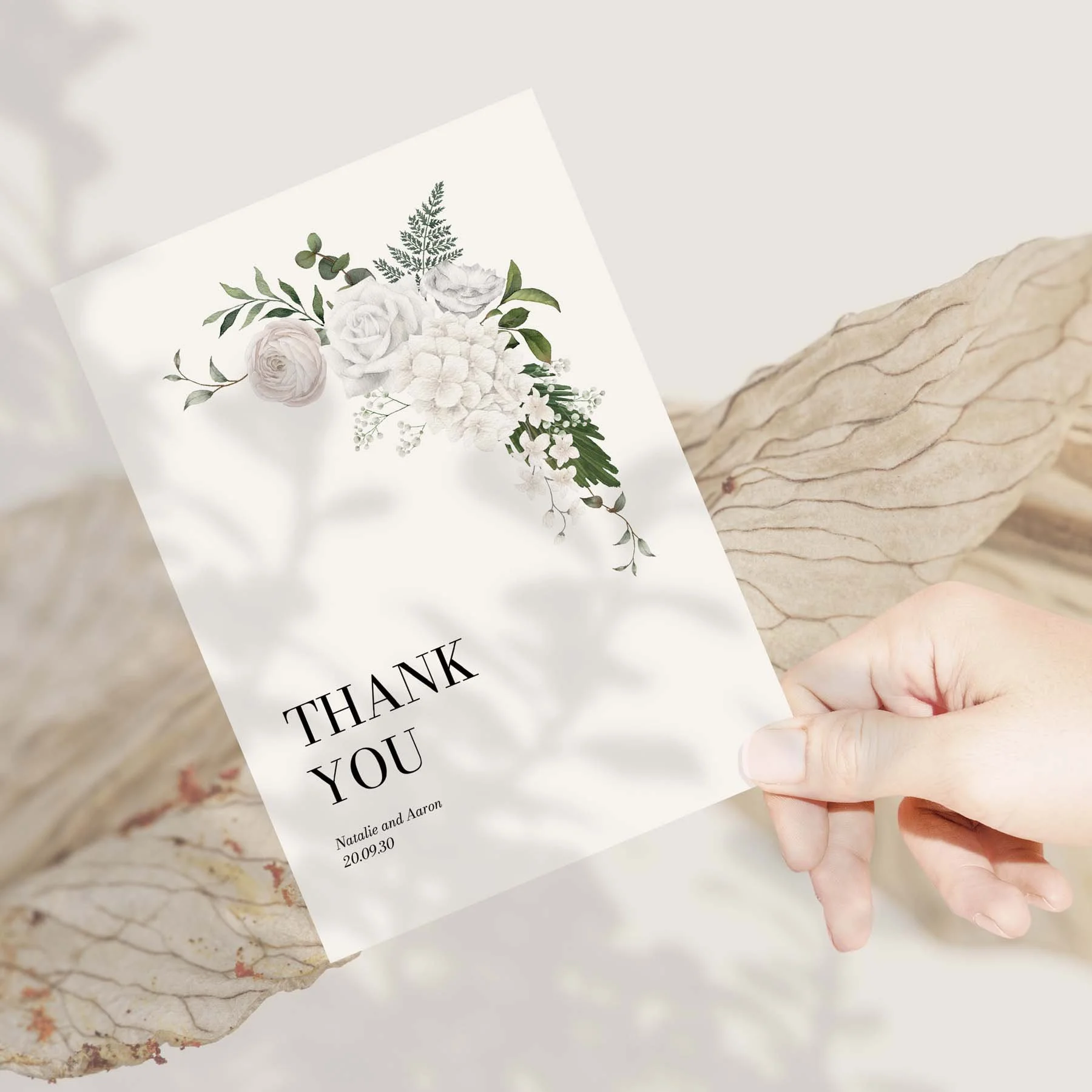 Hand holding a White Floral wedding thank you card
