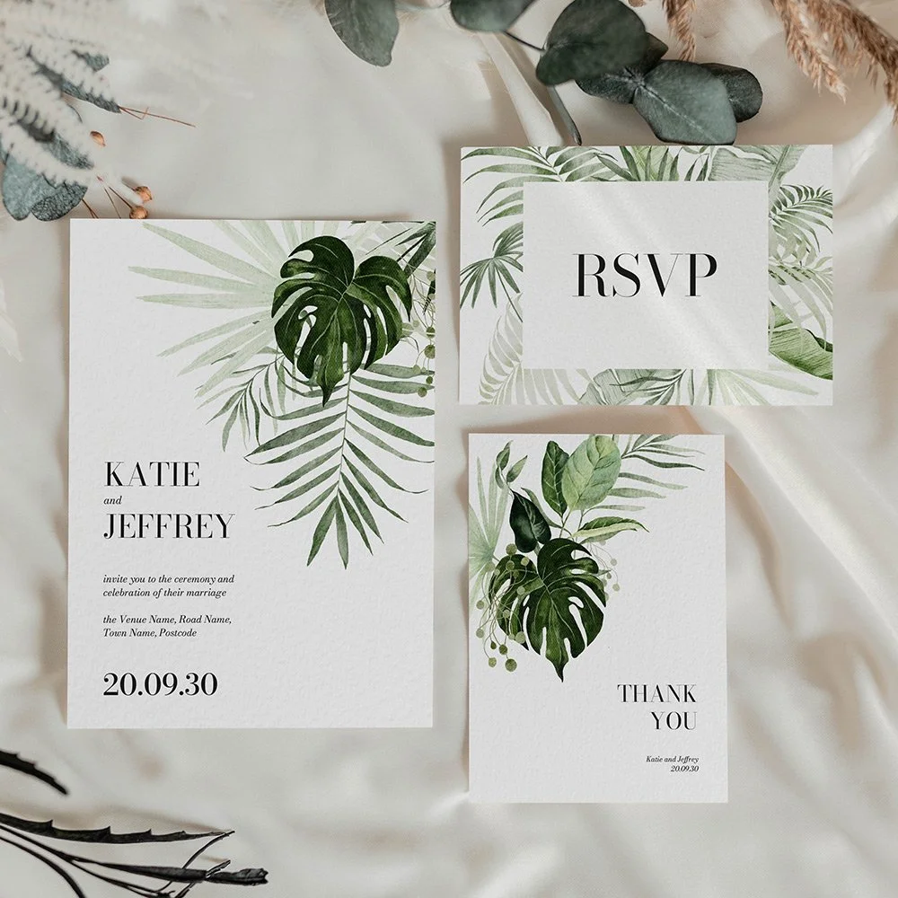 Tropical Collection flat wedding invitation, RSVP card, and thank you card featuring green palm and monstera leaves with sleek, modern typography.