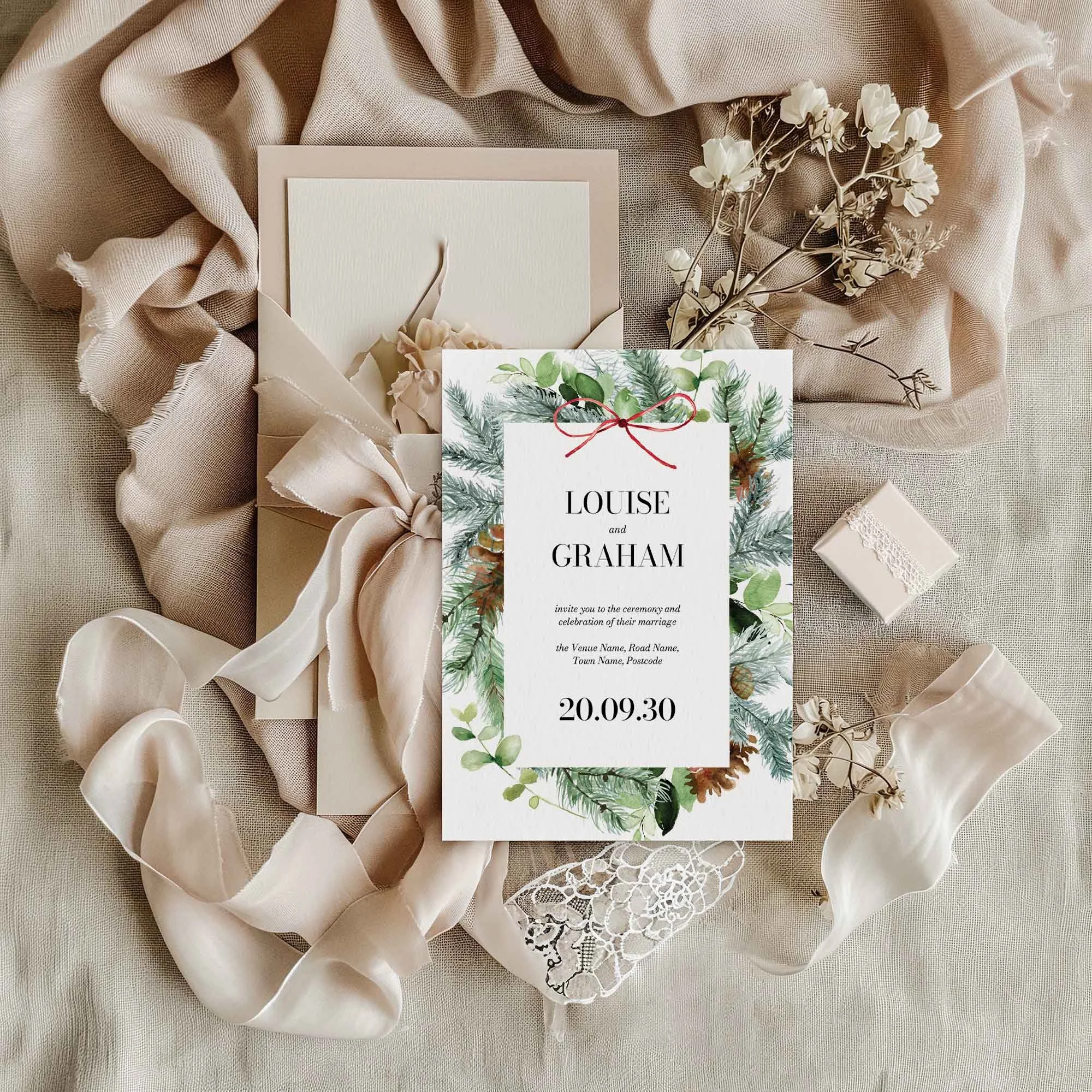 Christmas wedding invitation styled in a flat lay environment with wedding props