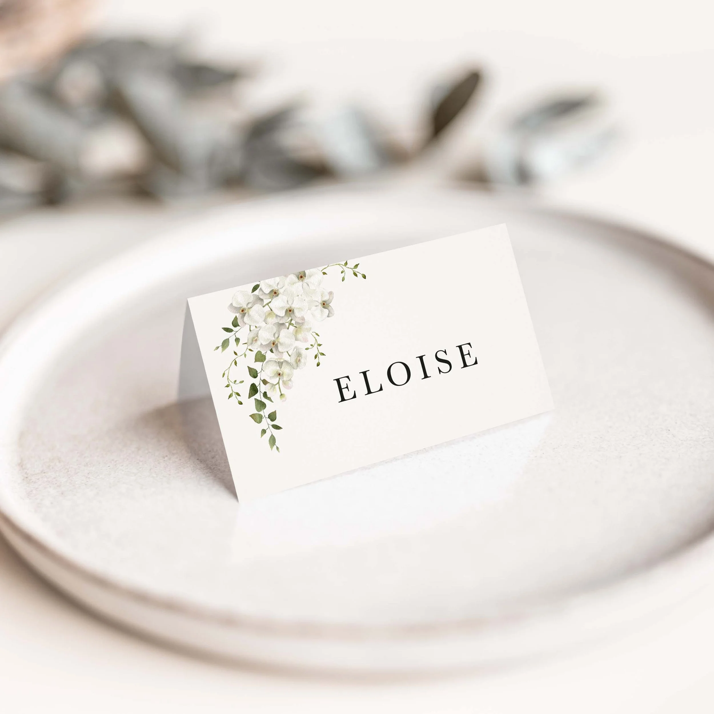 Garden wedding place card with trailing greenery and botanical detail
