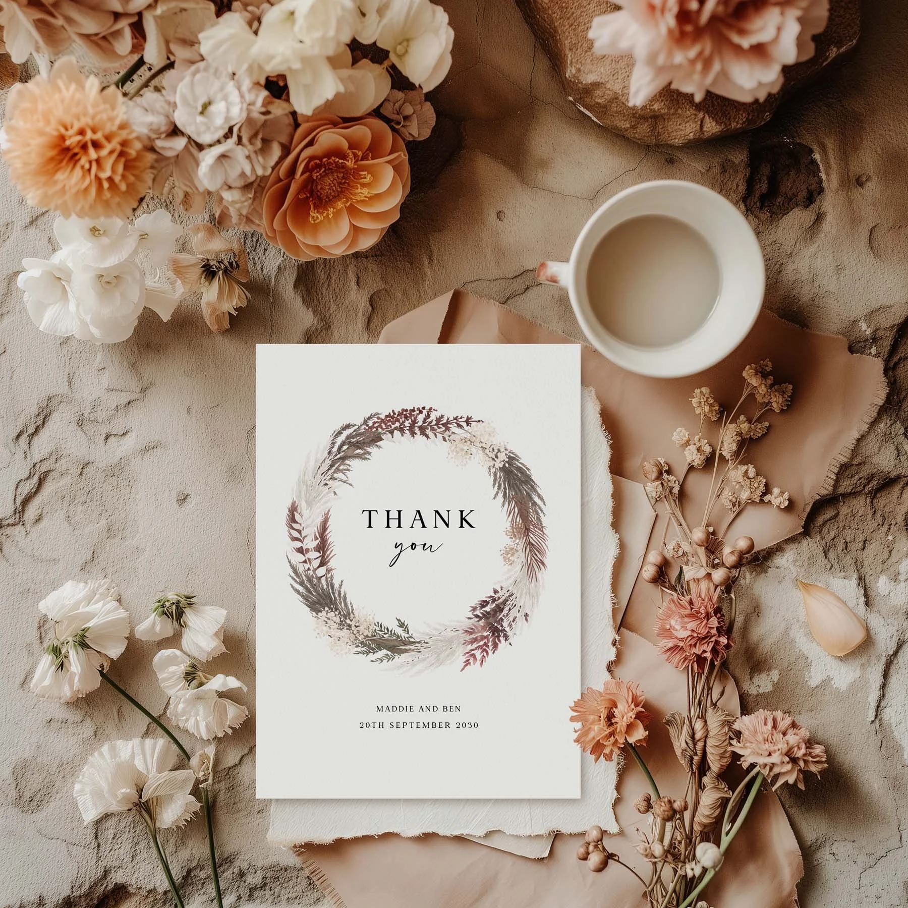 Blush Boho wedding thank you card with a dried botanical pampas wreath in blush and mauve tones, styled with dried flowers and a white cup on a neutral background