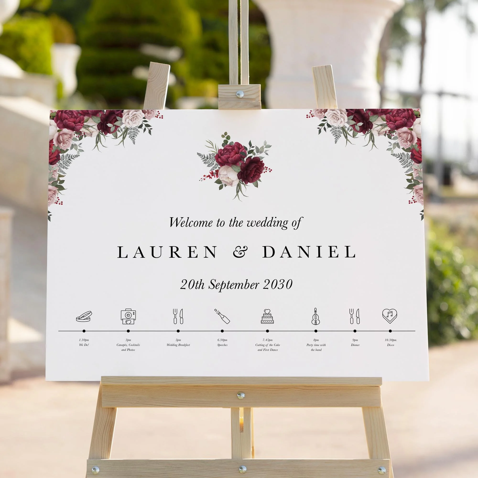 Burgundy and Pink Floral wedding welcome sign styled outdoors close-up