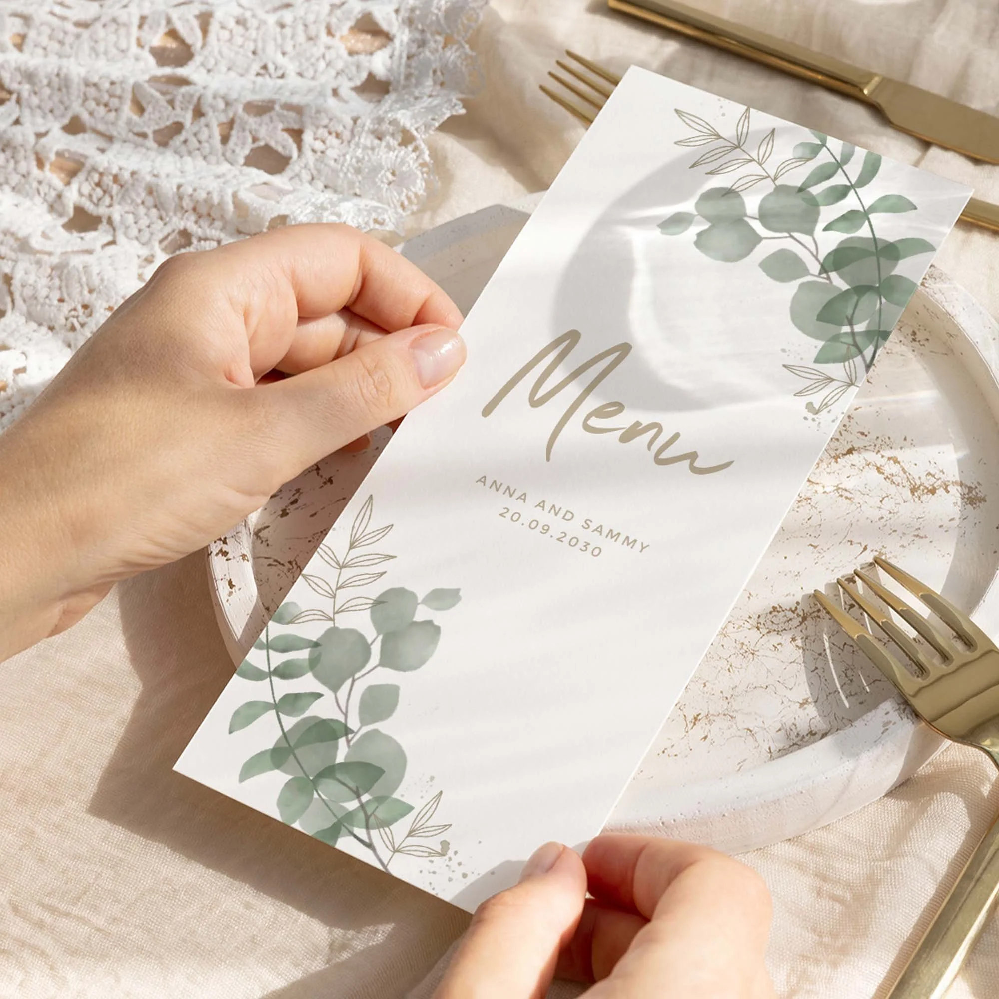Hand holding Eucalyptus wedding menu card showing size and printed design details