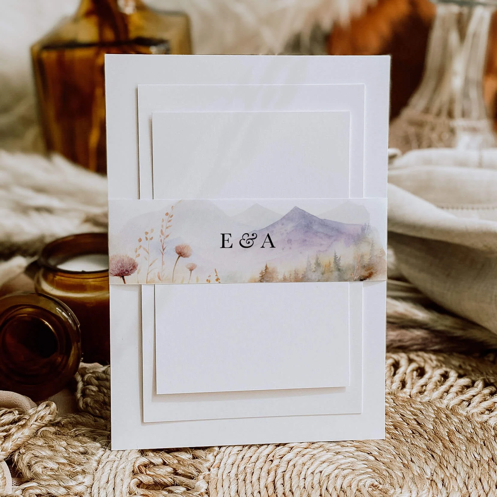 Scenic wedding belly band with soft mountain landscape watercolour design and personalised names wrapped around luxury invitation suite
