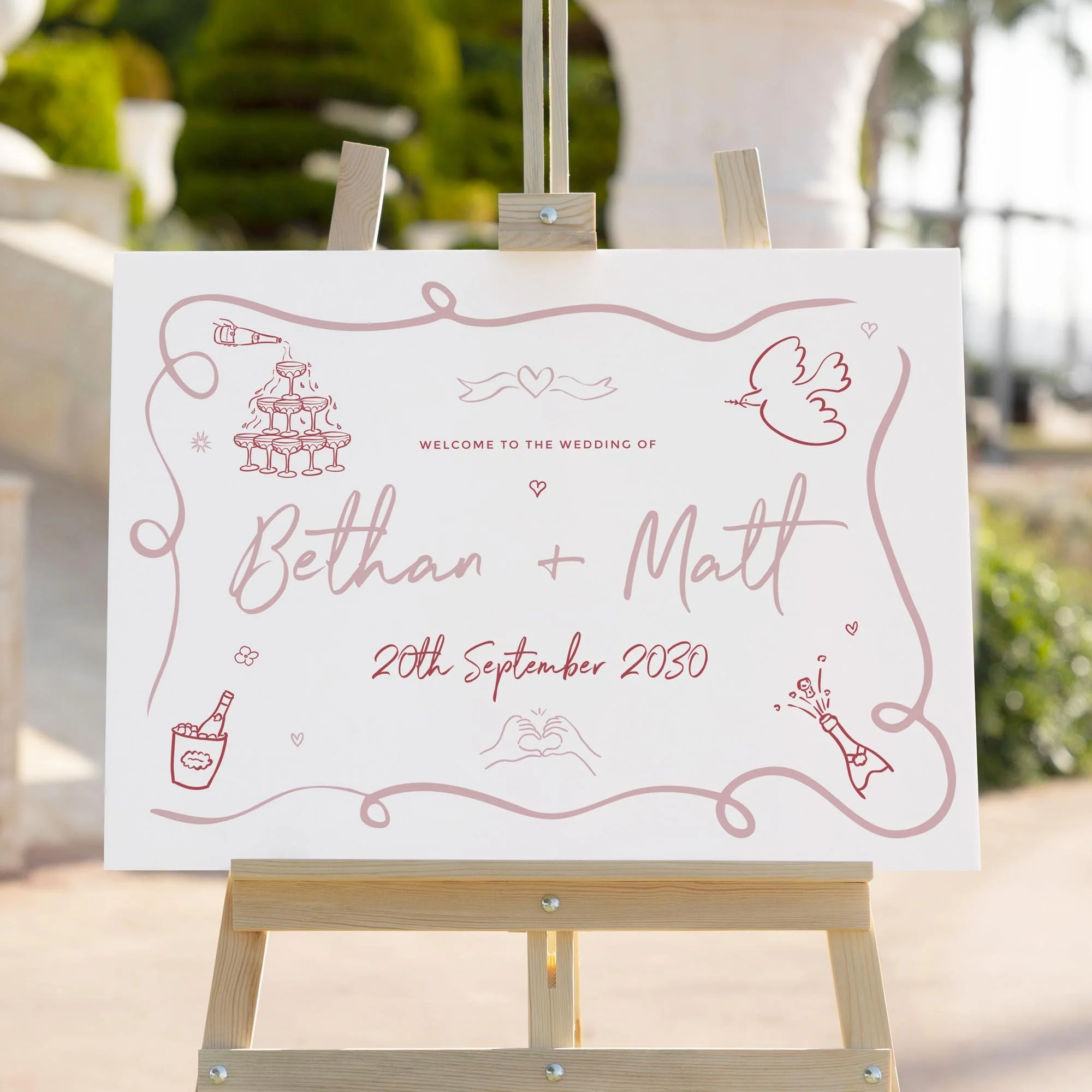 Pink Doodle wedding welcome sign styled outdoors close-up