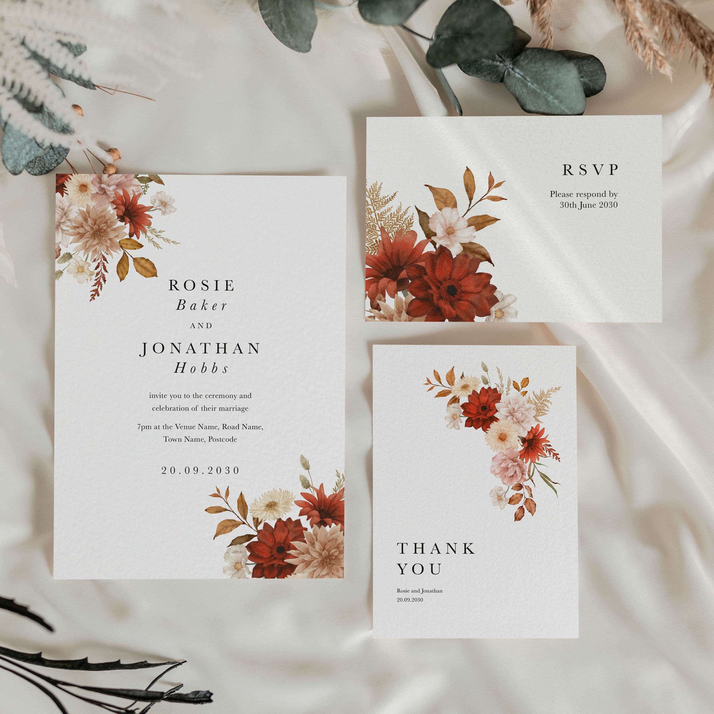 The Rustic wedding stationery collection showing invitation and menu card with a bold crimson and cream dahlia corner arrangement