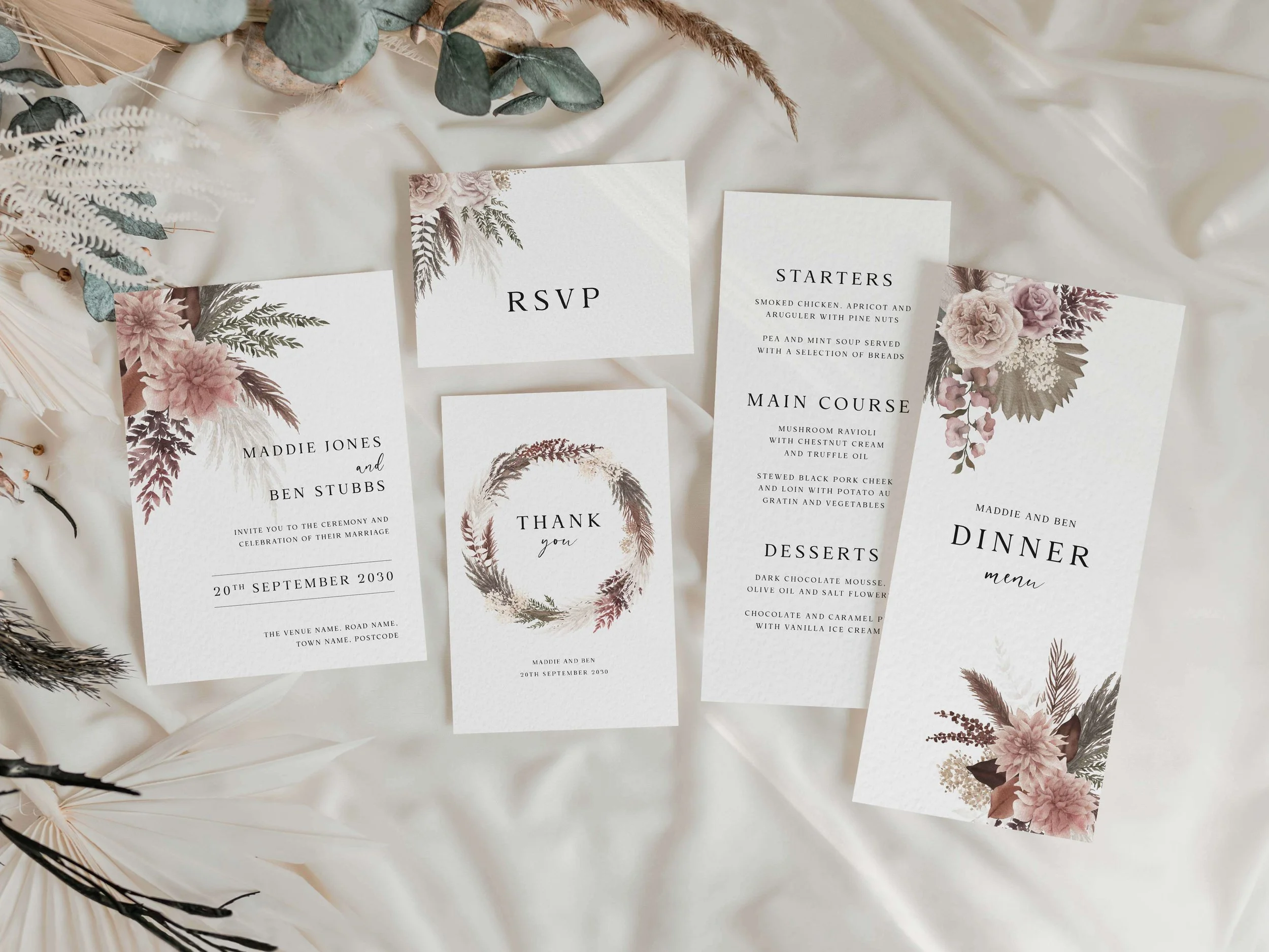 Full Blush Boho wedding stationery suite flat lay showing invitations, RSVP cards and coordinating pieces with pampas grass and blush pink floral design