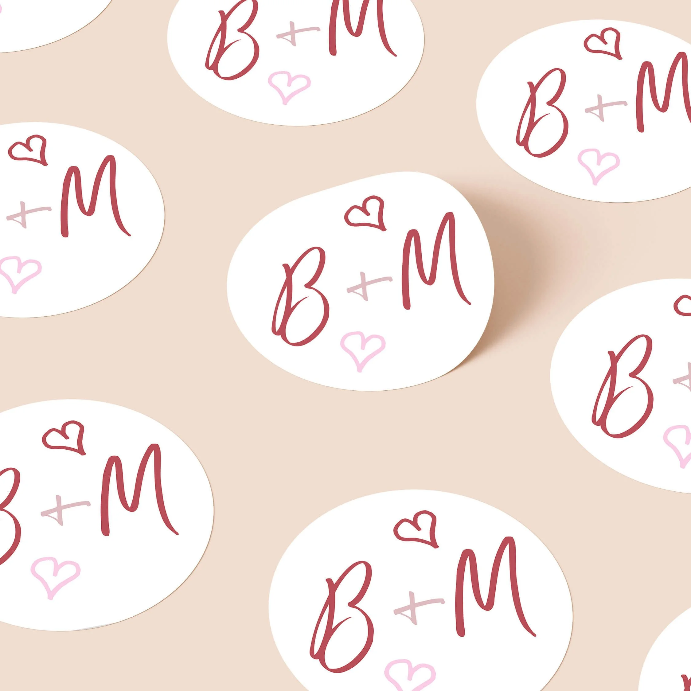 Whimsical Pink personalised wedding stickers with pink script initials and blush heart details on round white stickers