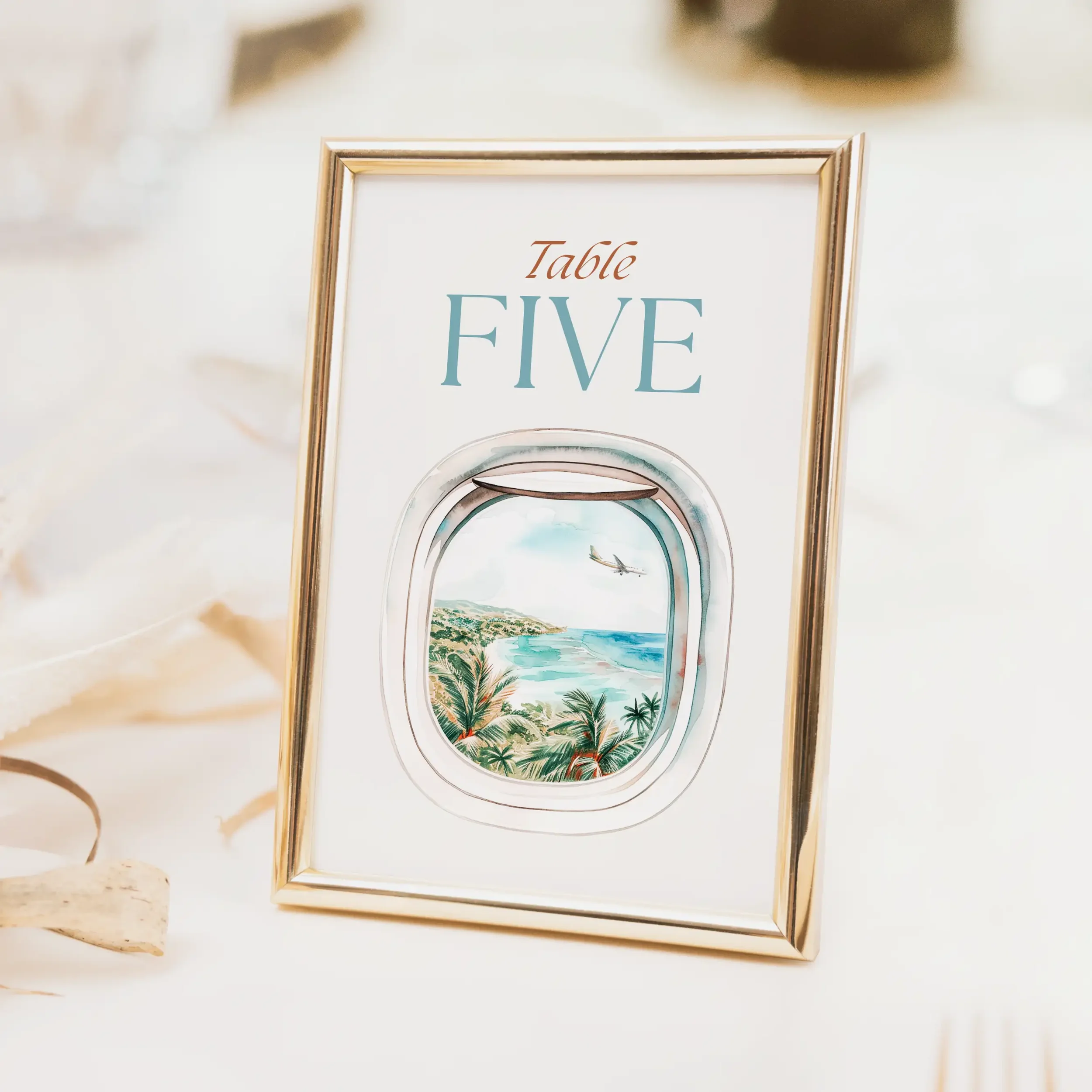 Explorer wedding table number with aeroplane window porthole illustration and elegant script typography on luxury off-white card