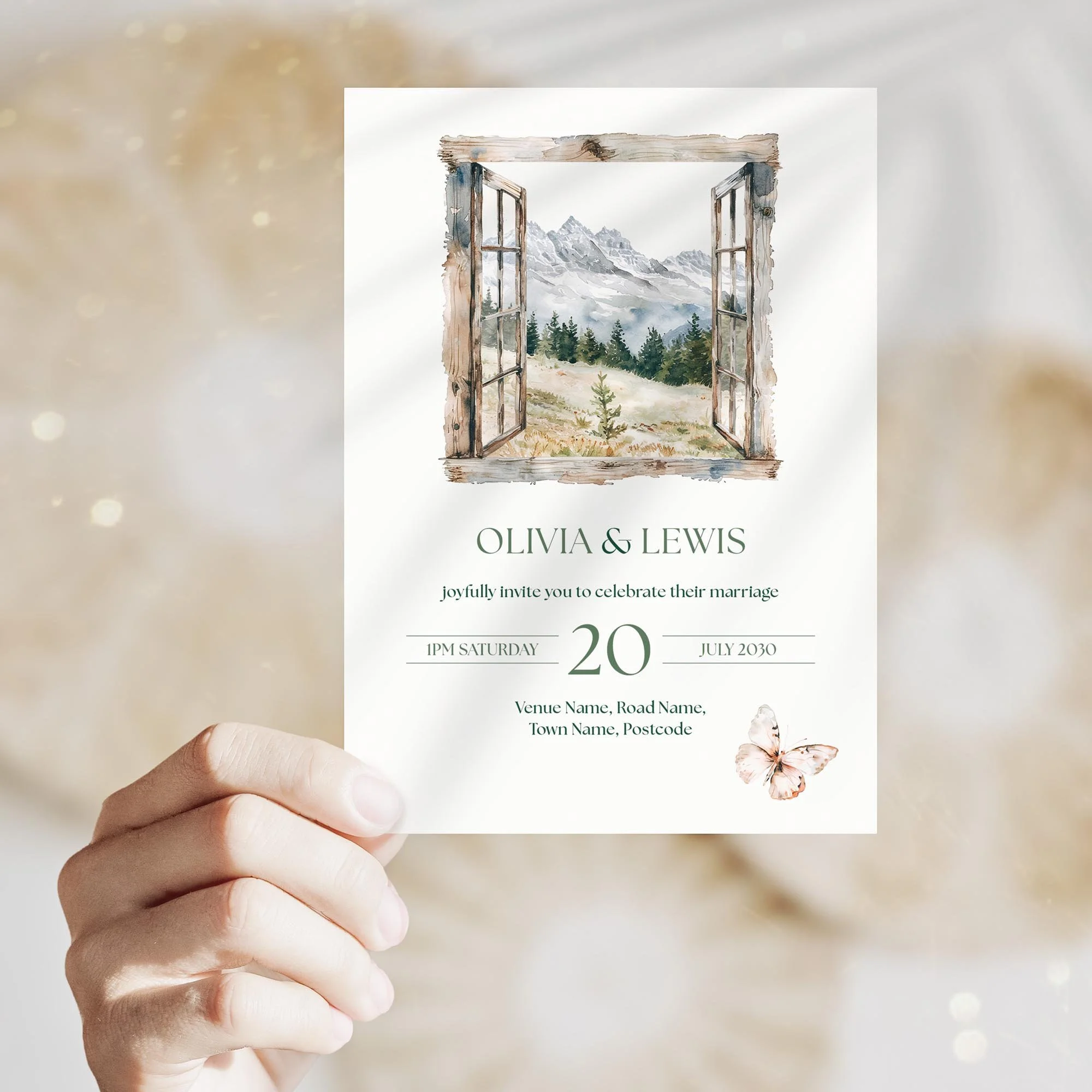 Person holding the Adventure Wedding Invitation featuring scenic mountain and tree view.