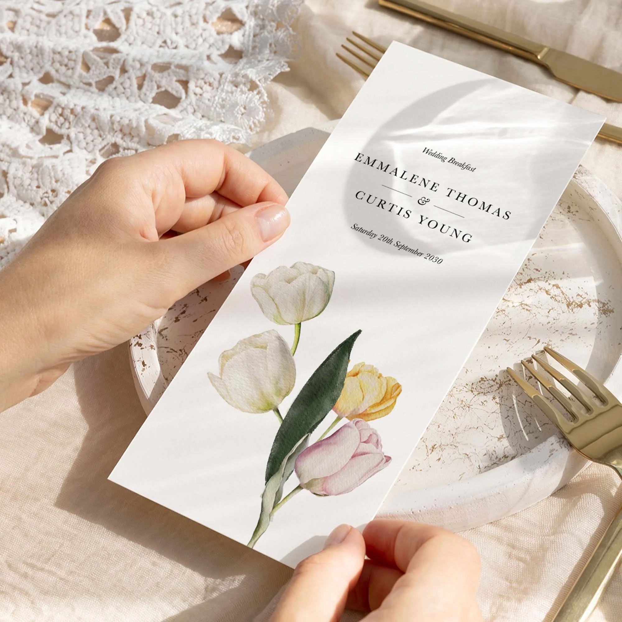 Hand holding Tulip wedding menu card showing size and printed design details