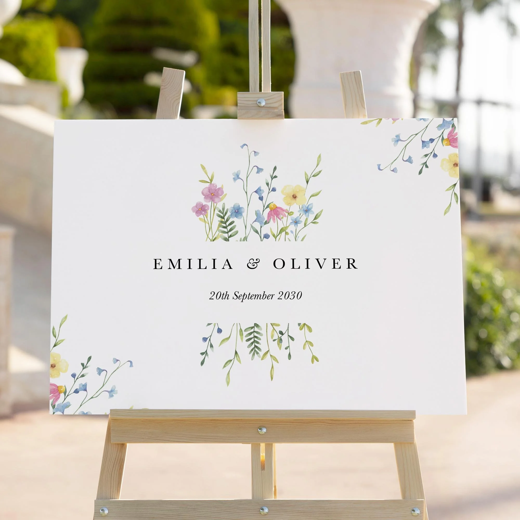 Colourful Wildflower wedding welcome sign styled outdoors close-up