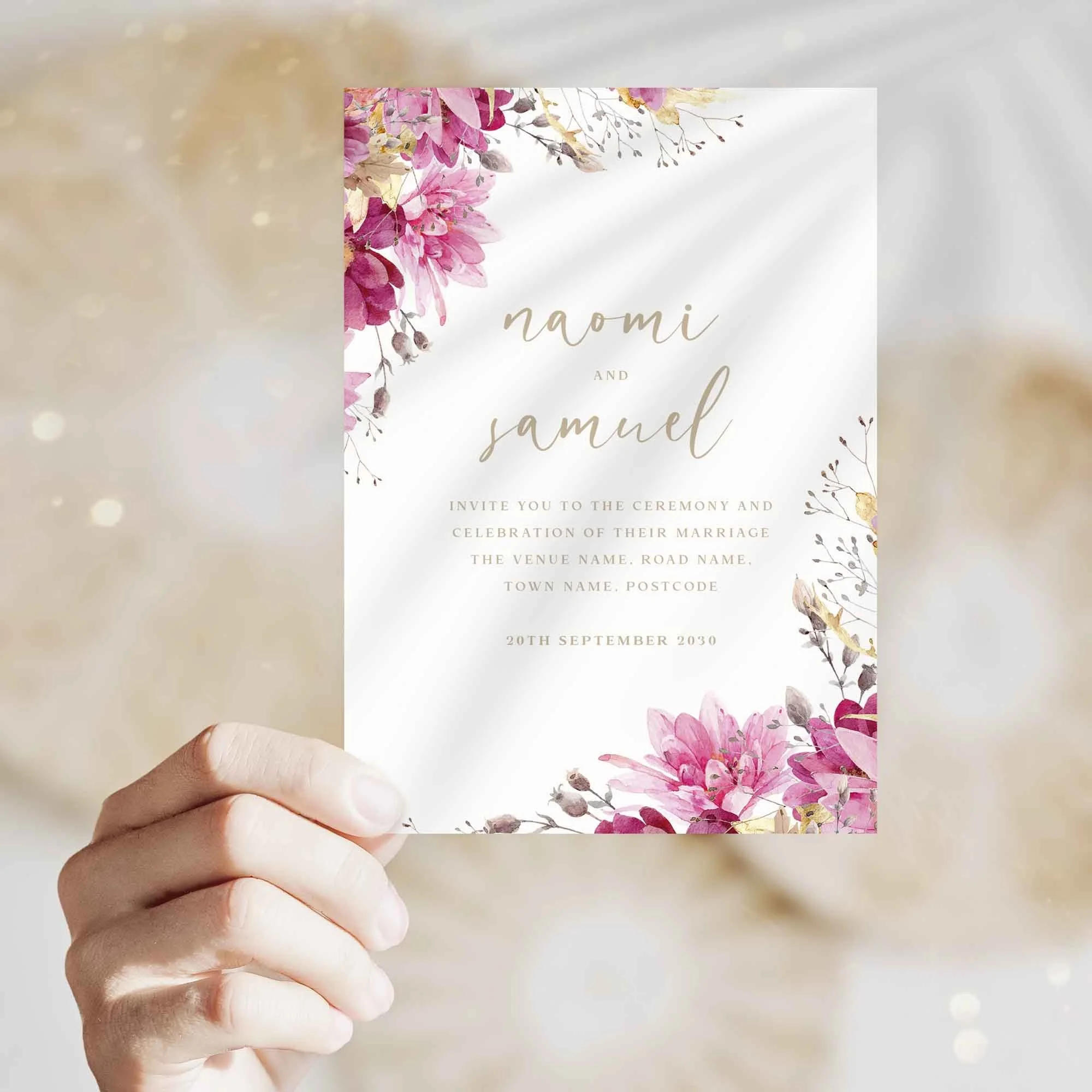 Hand holding Pink and Gold Floral wedding invitation showing size and printed design details