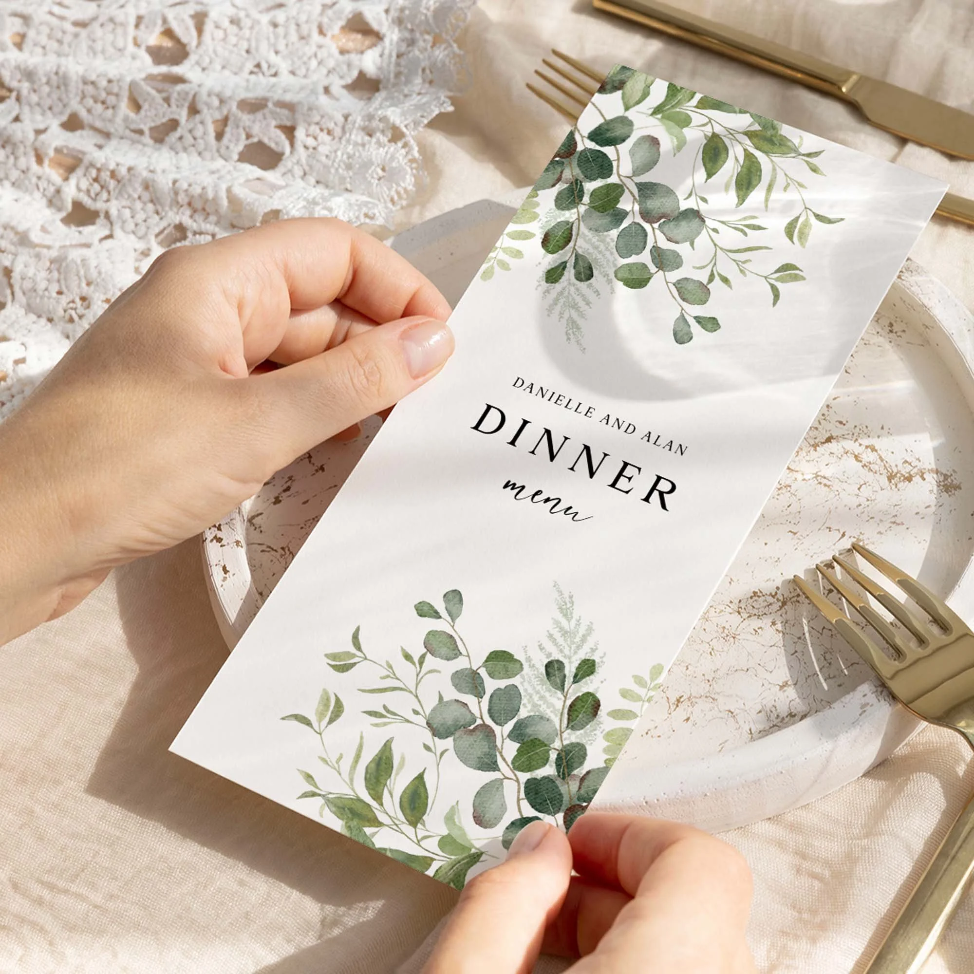 Hand holding Greenery wedding menu card showing size and printed design details