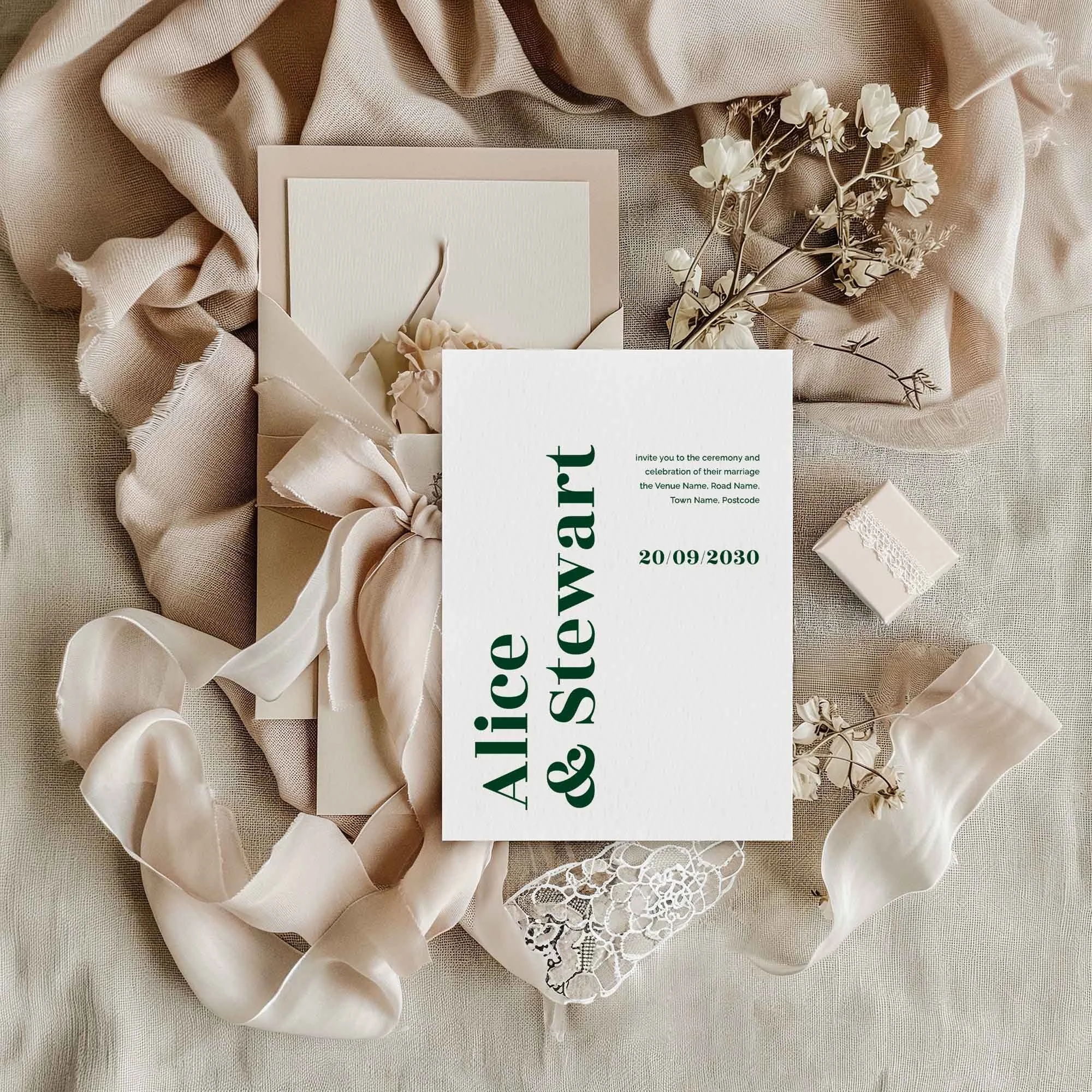Typography wedding invitation styled in a flat lay environment with wedding props