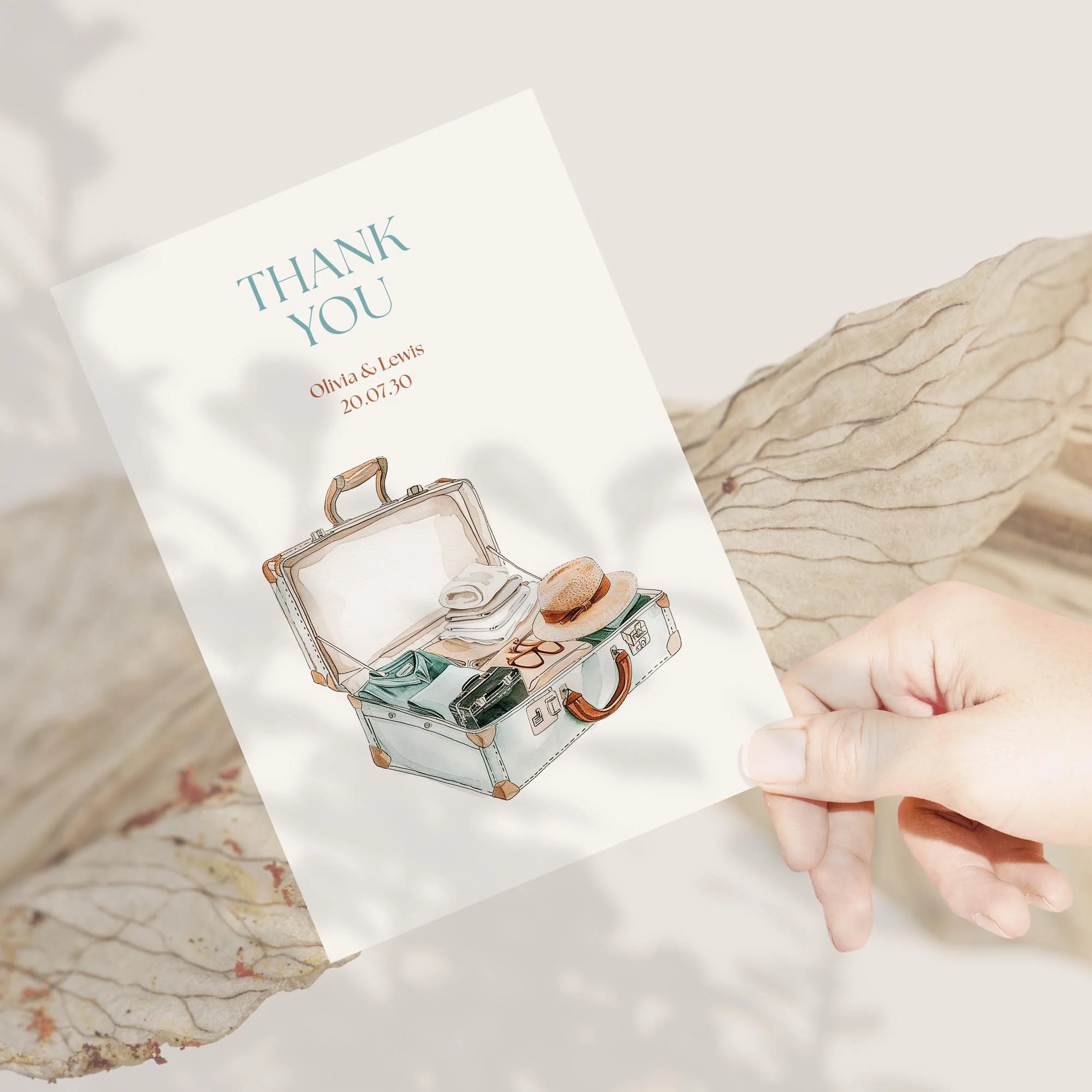 Person holding Explorer Wedding Thank You Card with suitcase design.