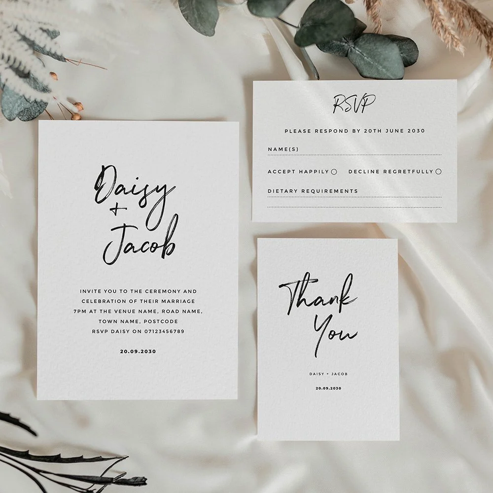 Minimalist black and white wedding stationery suite with bold calligraphy and modern typography on a clean white background.