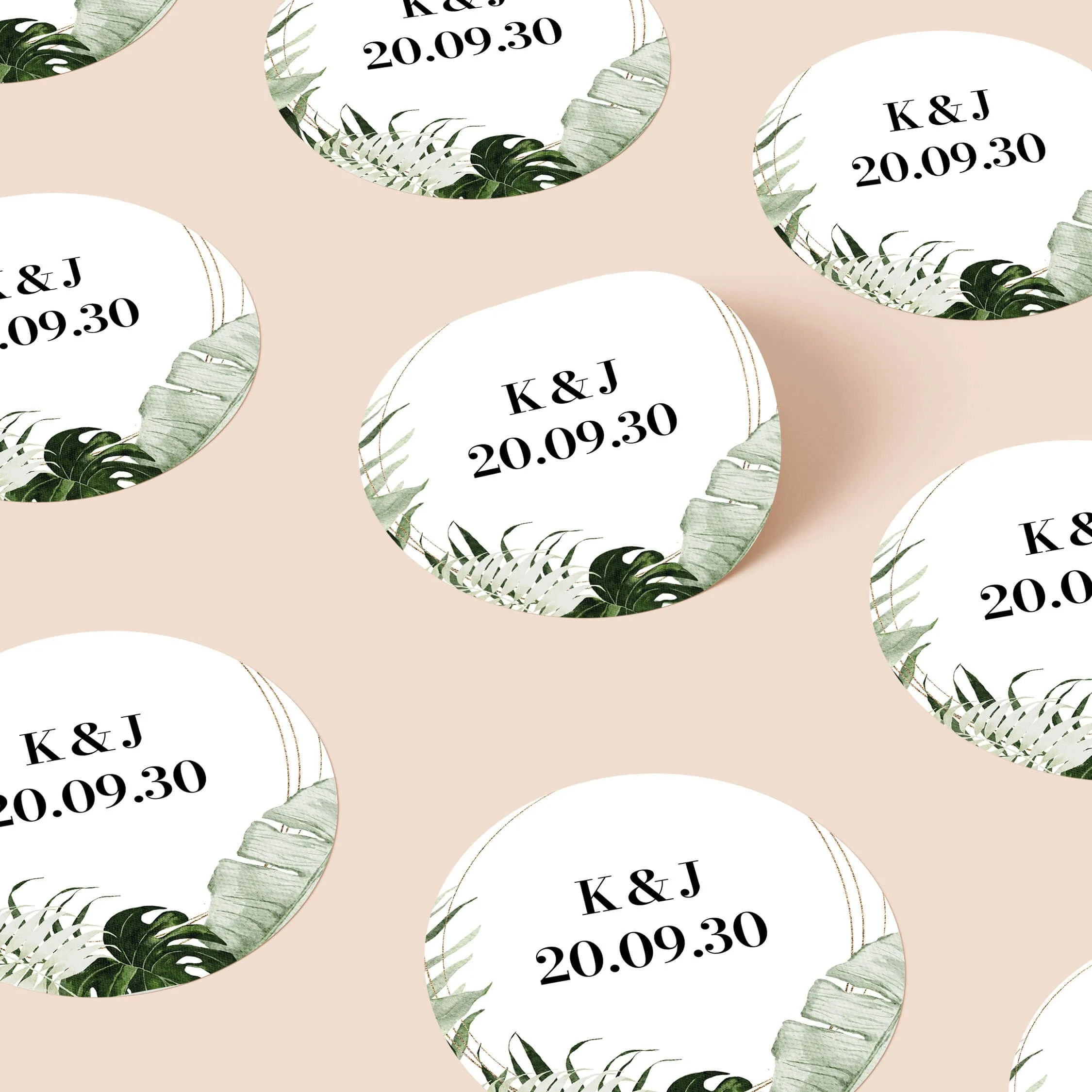 Tropical personalised wedding stickers with monstera palm leaf border and gold frame design on round stickers