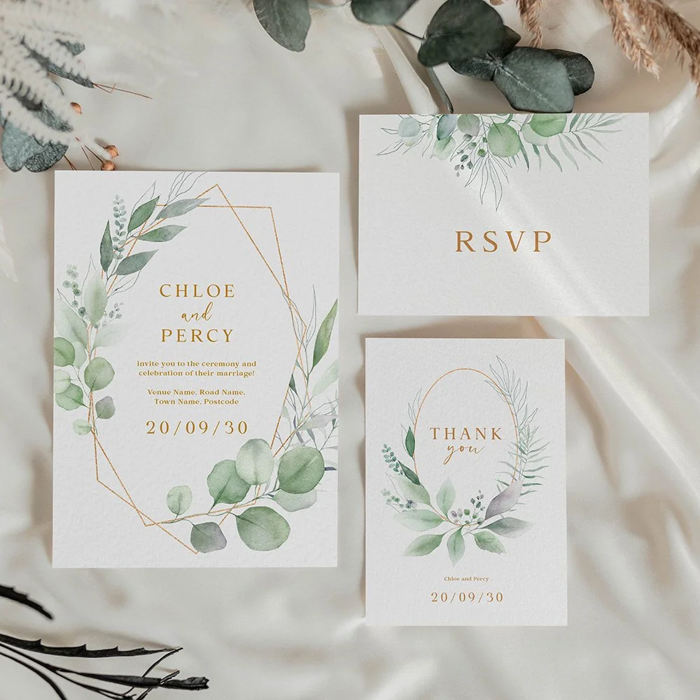 Save the date card with eucalyptus foliage wrapped around a copper frame and copper text, combining greenery with a warm, modern design.