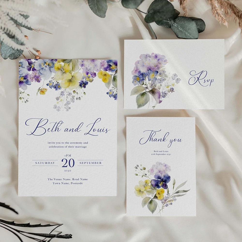 Wedding stationery suite featuring purple and yellow violet flowers with elegant purple typography