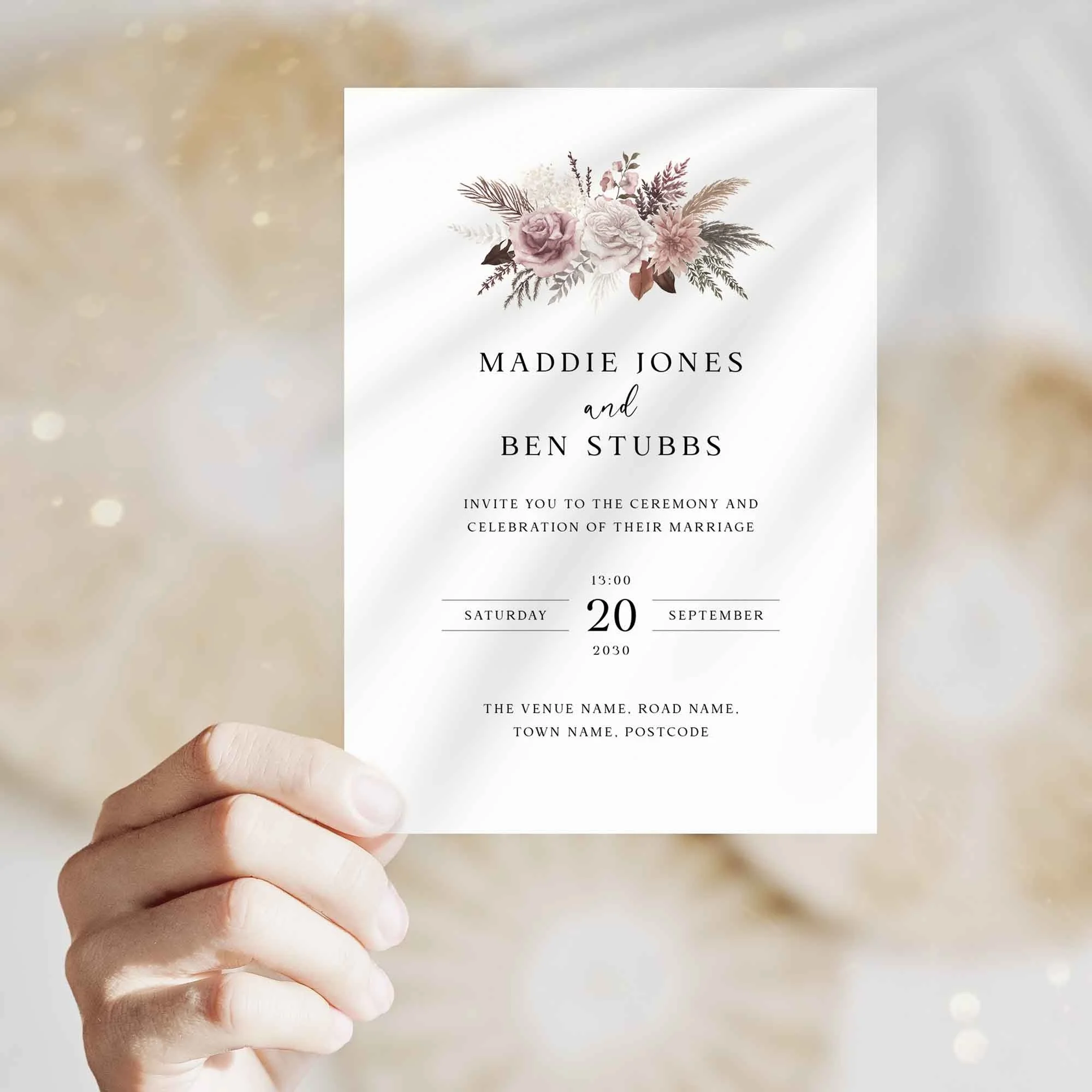 Hand holding Pink Pampas wedding invitation showing size and printed design details