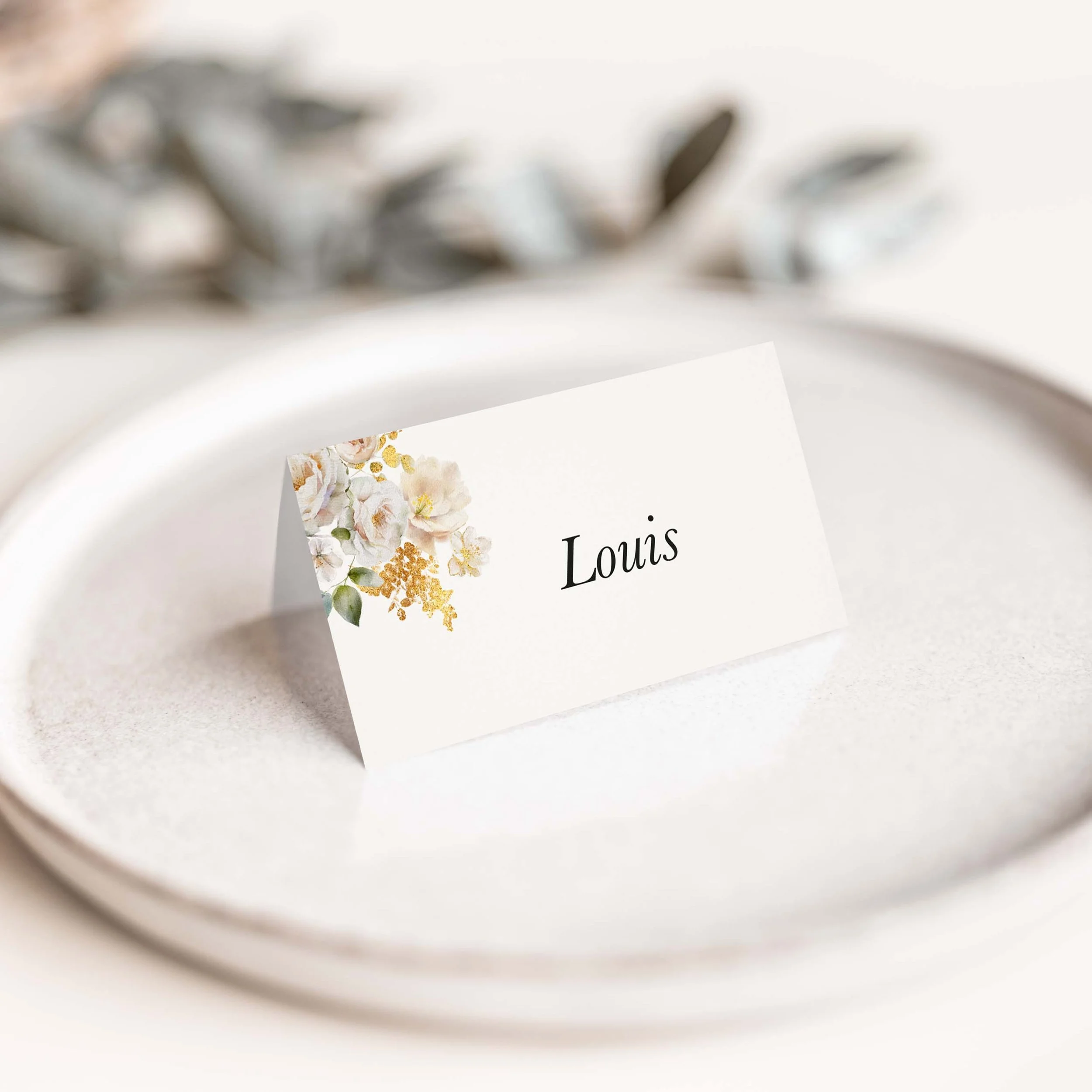Ethereal floral wedding place card with soft white flowers on luxury off-white card