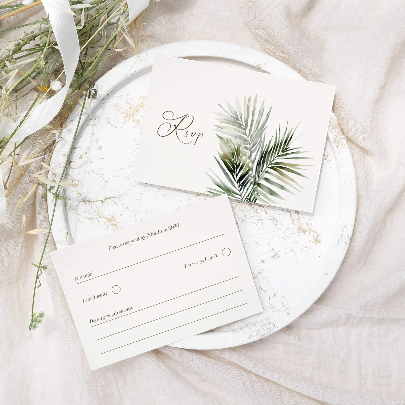 Island wedding RSVP card with watercolour tropical palm leaf illustration and script typography on luxury off-white card