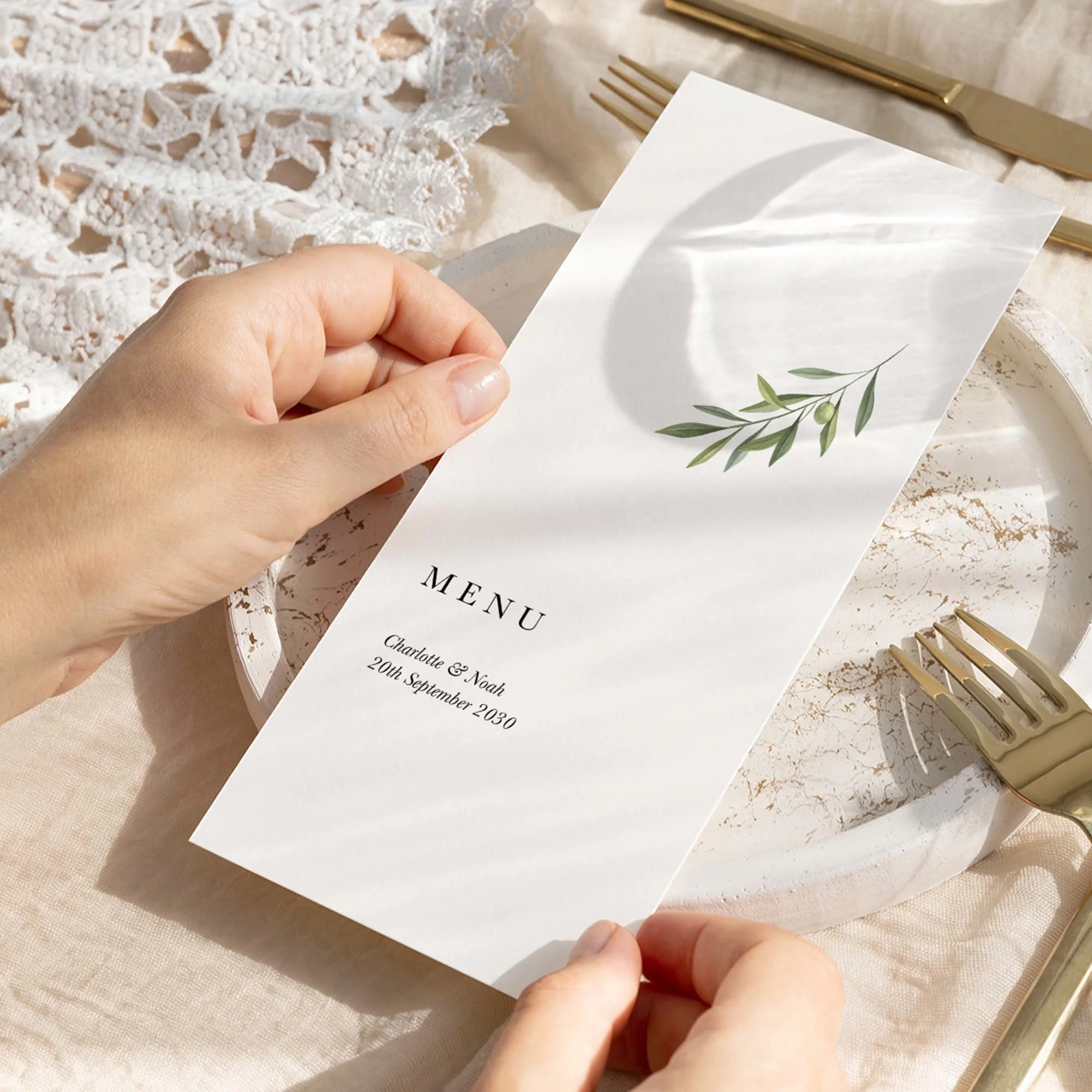 Hand holding Simple Olive Branch wedding menu card showing size and printed design details