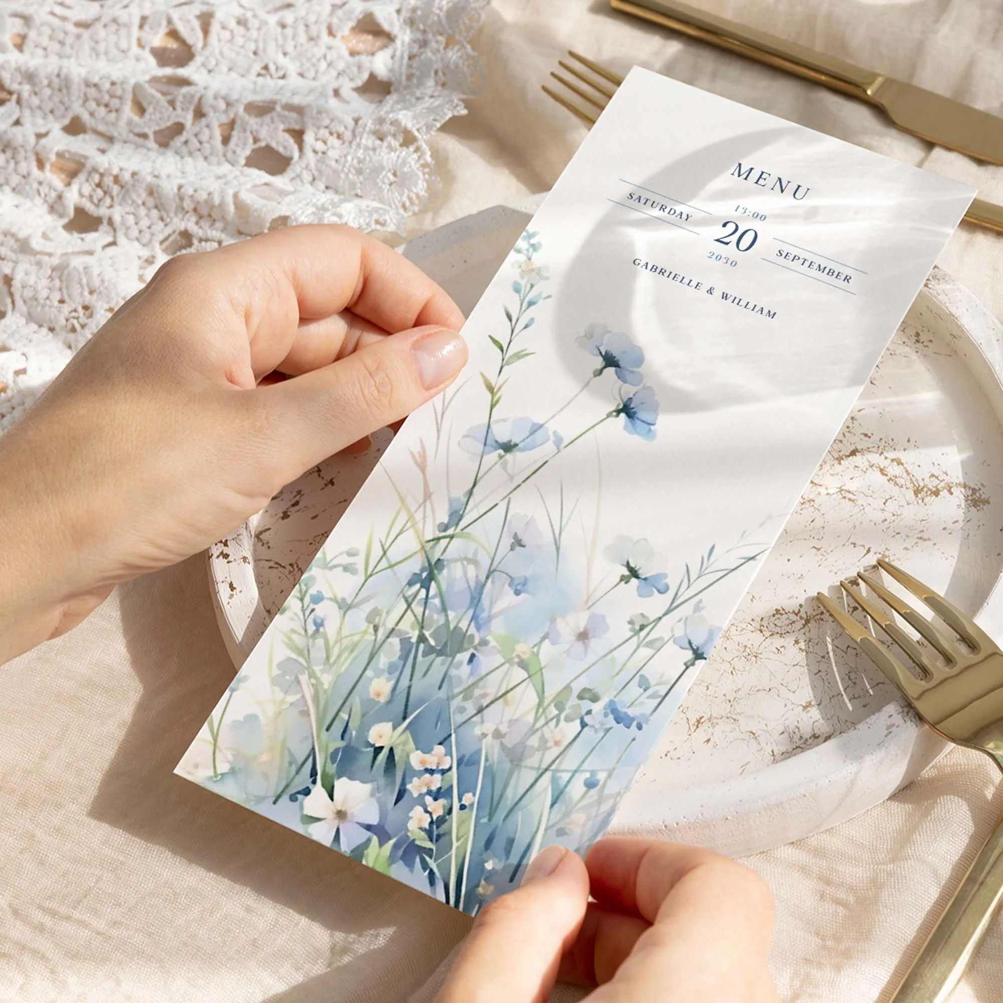 Hand holding Dusty Blue Wildflowers wedding menu card showing size and printed design details