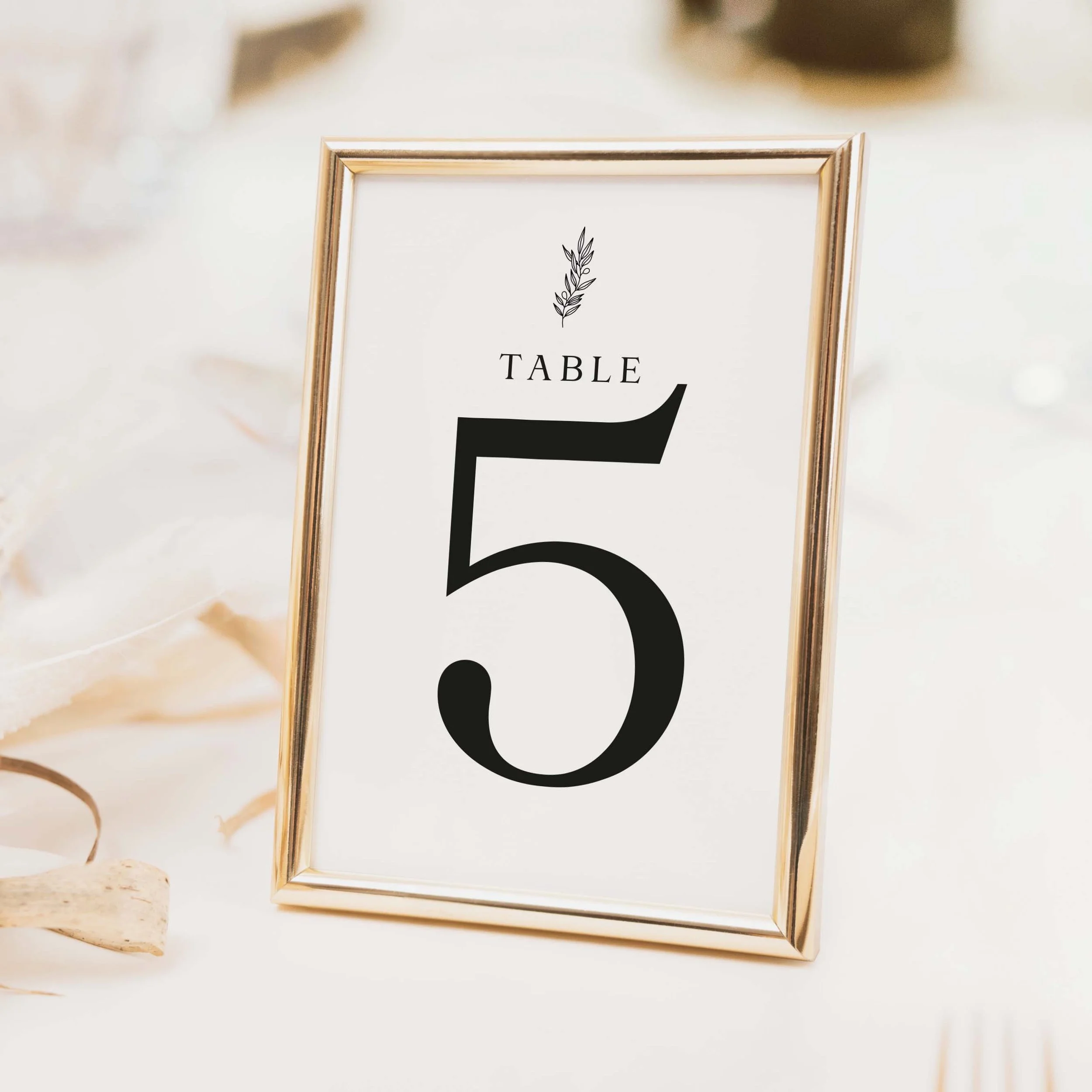 Heritage wedding table number with bold serif typography and large clean numeral in classic typographic style on luxury off-white card