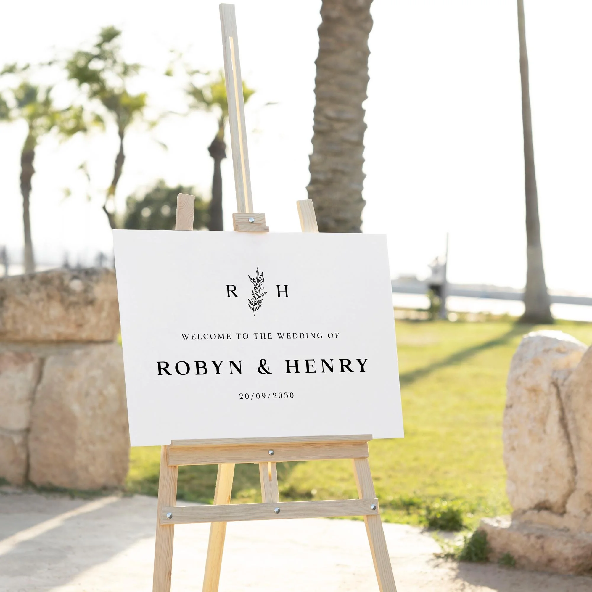 Modern Botanical Monogram wedding welcome sign displayed outdoors at a wedding venue on an easel