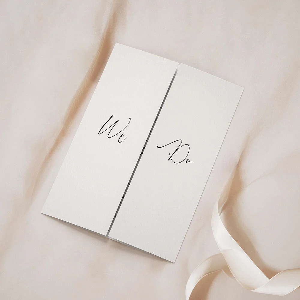 Autograph Collection gatefold wedding invitation closed, featuring bold black calligraphy typography on a crisp white background.