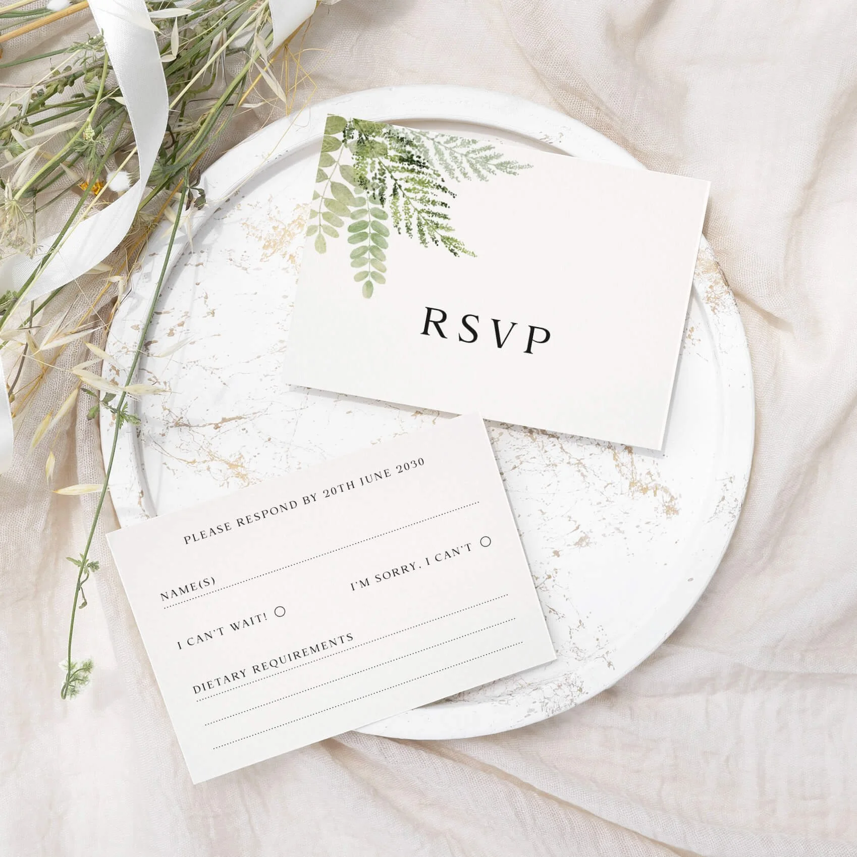 Greenery wedding RSVP card with watercolour fern and botanical leaf illustration on luxury off-white card