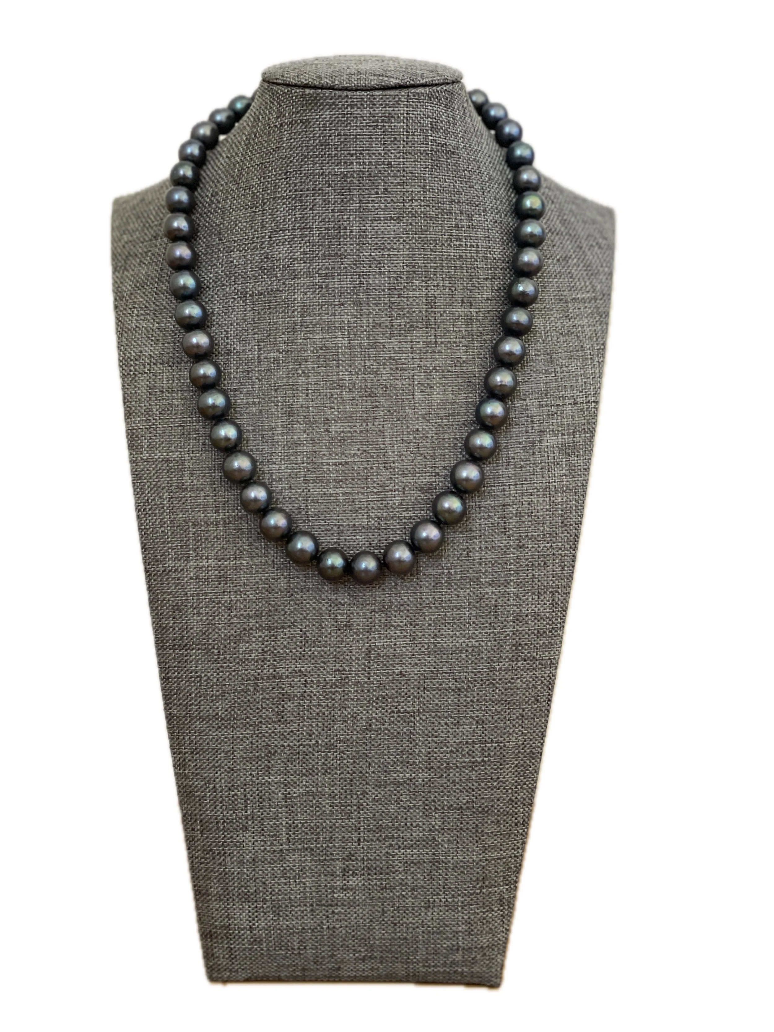 A striking 18-inch necklace of lustrous 10mm black pearls, knotted for beauty and durability and finished with a sterling silver lobster clasp