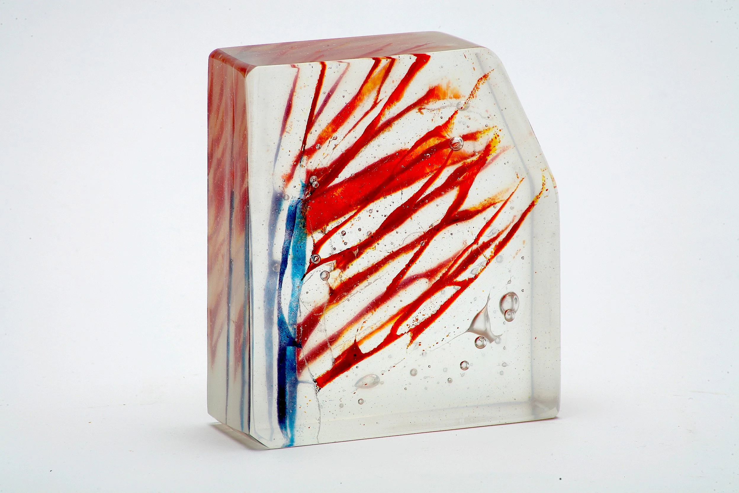 This striking cast fused glass piece by award-winning artist and Shermanite Kenny Litwack, showcases the brilliant color and movement that define his work. Approximately 5” x 4.5” x 1”