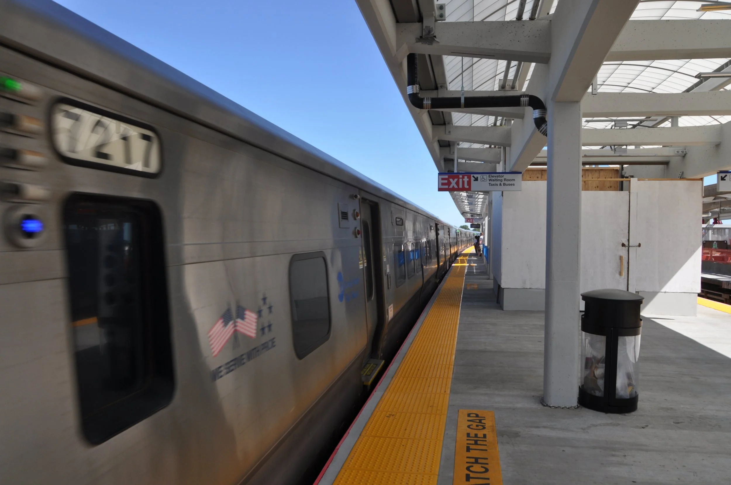 Commuter rail platform canopy protected by bird deterrent system targeting pigeons.