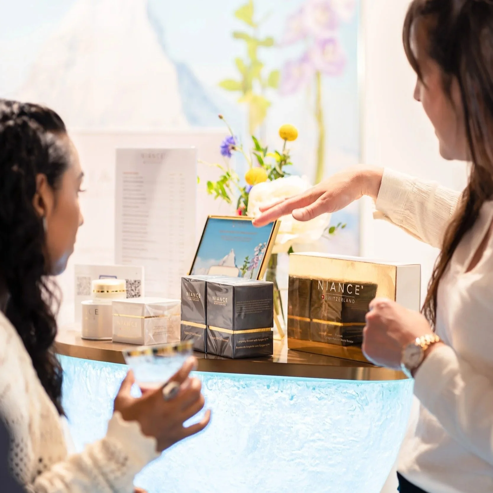 Image of two people discussing NIANCE beauty products at VOLTA Basel 2025.