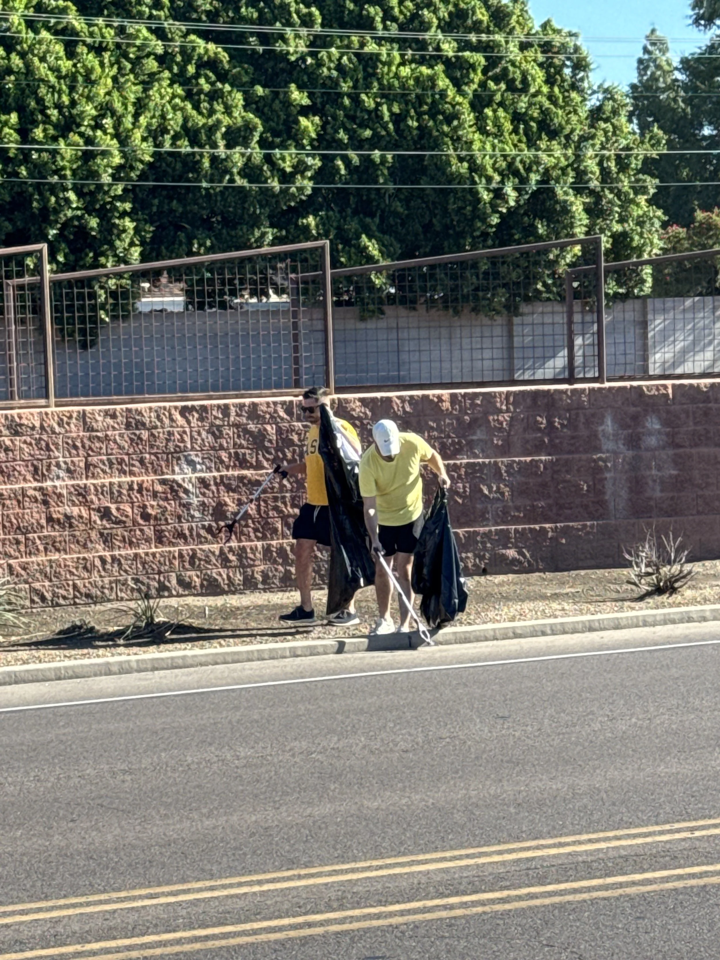 Volunteers from Phoenix Arcadia Rotary Club picking up litter near Osho Brewing Company on Indian School Road during Own the Street Day in Arcadia, Phoenix