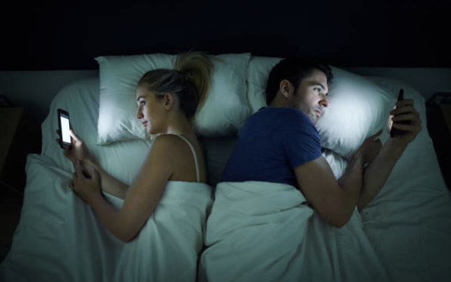 Couple in bed facing opposite directions due to intimacy issues