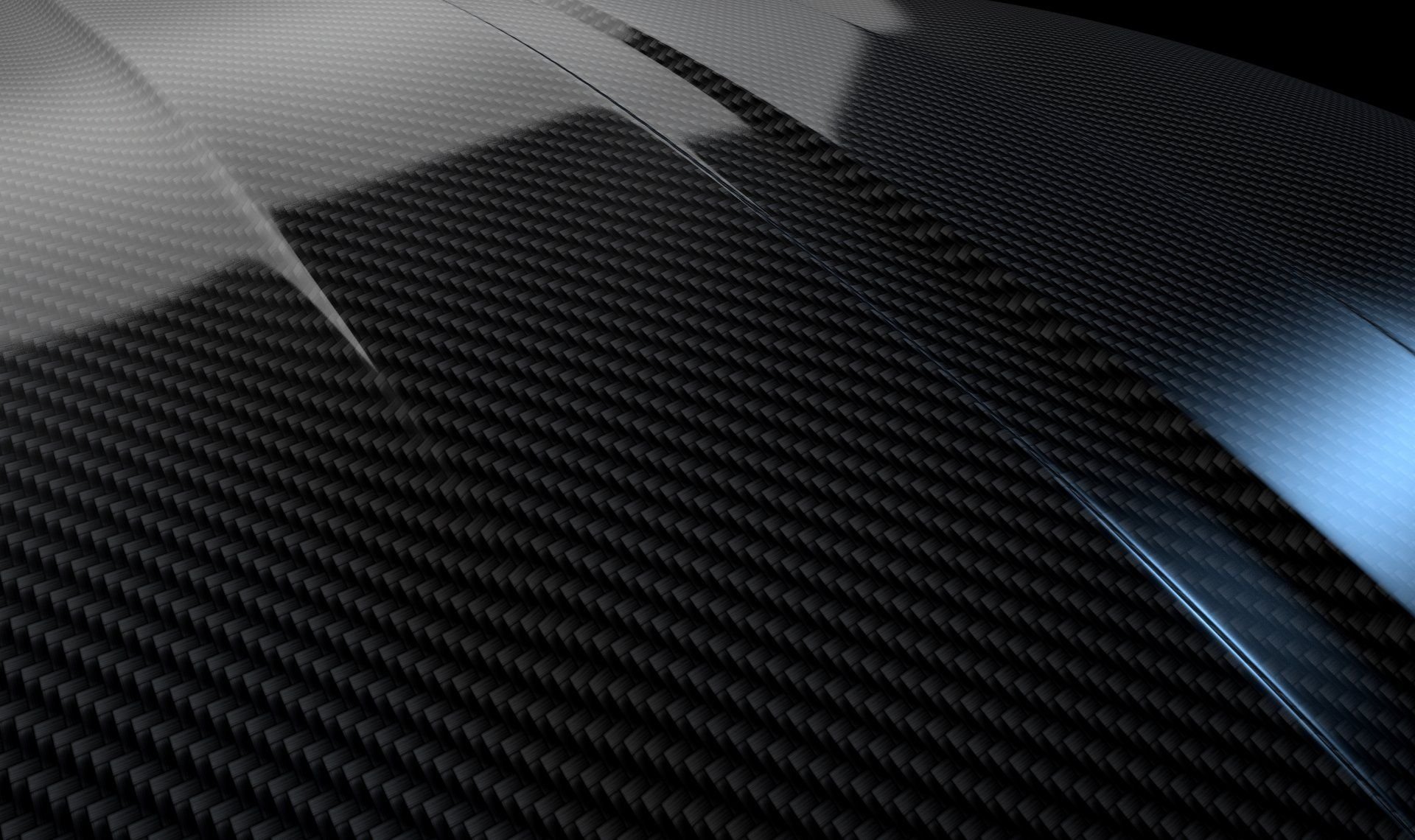 Close-up of a sleek, black carbon fiber surface with glossy and matte finish sections.