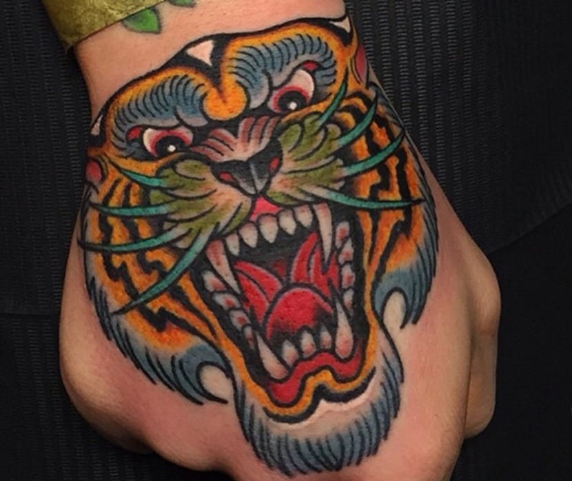 traditional hand tiger tattoo.jpeg