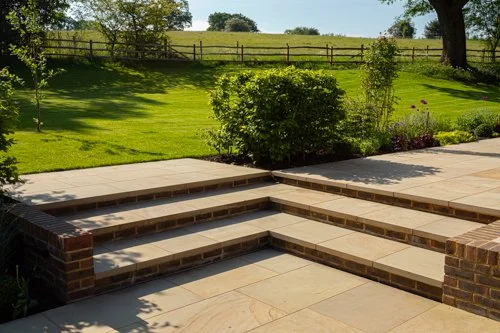 The crisp clean lines of the York stone paving are set off by the brick risers and low walls. 