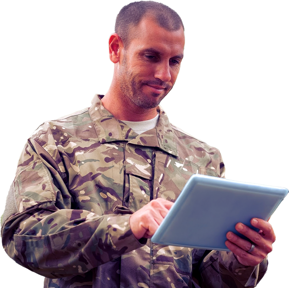 A man in camouflage military uniform using a tablet.